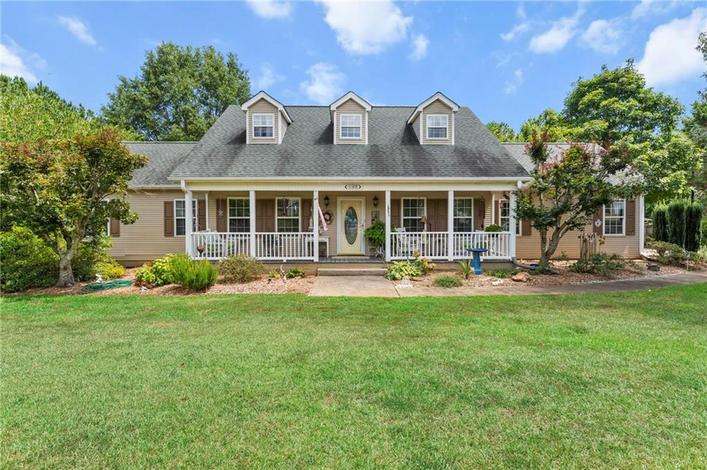 Welcome to your own slice of serenity in beautiful Hartwell, GA! Nestled on a lush, landscaped 1-acre lot, this 4-bedroom, 3-bathroom traditional-style home offers the perfect blend of classic charm and modern comfort. Built in 1999, this well-maintained home features a spacious and flexible floor plan ideal for families, remote workers, or anyone seeking room to breathe. The main level boasts a generously sized primary suite, a second bedroom, and a versatile den or office-perfect for working from home or cozy movie nights. Upstairs, you'll find two additional bedrooms, a full bath, and a cozy loft space that's ideal for a reading nook or playroom. Step outside to enjoy multiple outdoor living spaces designed for both relaxation and entertaining. A spacious deck off the main house offers the perfect spot for morning coffee or evening gatherings under the stars. Just steps away, the detached garage/workshop features two covered patios, providing shaded retreats ideal for grilling, lounging, or simply enjoying the peace and quiet of your private backyard oasis. Don't forget the fully landscaped yard is kept lush with the help of public water plus two private wells, dedicated just for irrigation. Out back, unwind by the firepit, and enjoy a taste of country living with a charming shed currently used as a chicken coop. With no HOA, you have the freedom to live how you like-bring your toys, your hobbies, and your chickens! Outdoor lovers, take note-this home is just minutes from Lake Hartwell, with multiple public boat ramps located within a 2-mile radius. Whether you're into fishing, boating, or lakeside picnics, you'll have quick and easy access to it all. Don't miss this rare opportunity to enjoy peaceful living, unmatched flexibility, and endless outdoor fun-all in one perfect Hartwell location!