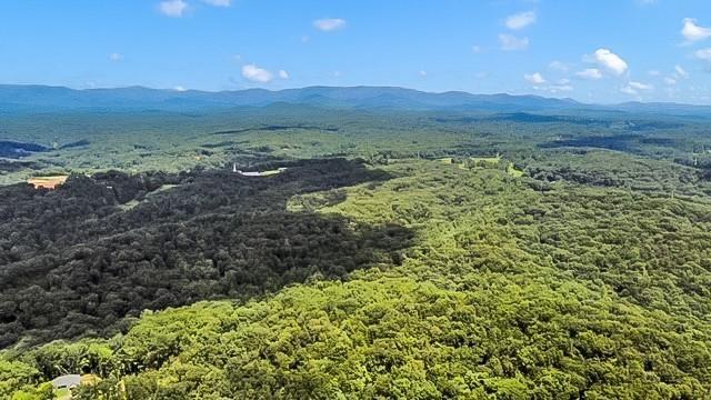 At 5.35 +/- acres, you can build just about any home. This lot is very private, sits way up high and flattens out up top to a beautiful building spot with a babbling creek and waterfalls. Creeks border both sides. If tranquility is what you are looking for, then look no further. Minimum sf is 3500 above grade. This lot can be a slab, walk out back yard with side daylight basement or a walk out basement.