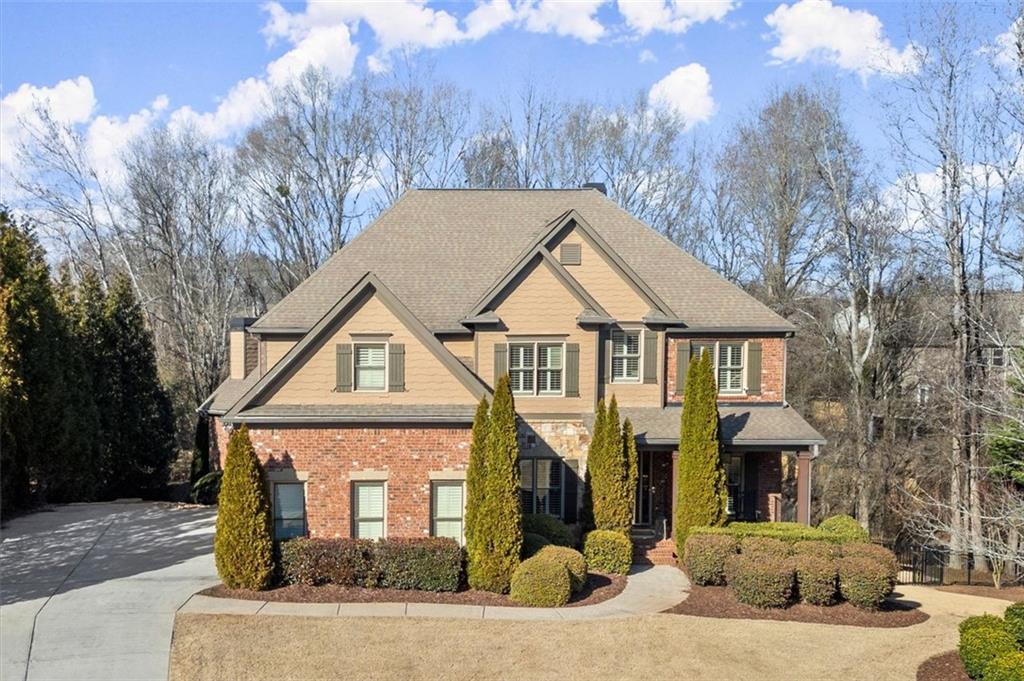 Discover the epitome of elegance and comfort at 5245 Wilshire Crossing, located in the popular Telfair neighborhood. This exquisite home, custom-built by Alex Tetterton, offers a harmonious blend of luxury and functionality, and is conveniently close to top schools, parks, walking trails, and shopping.
Upon entering, you're welcomed by high ceilings and hardwood floors that flow into the bright family room, where an elegant coffered ceiling and oversized stacked stone fireplace create a perfect setting for cozy evenings.
Adjacent is the open kitchen, complete with granite countertops and a butler's pantry, making it ideal for hosting gatherings. The formal dining room, adorned with plantation shutters, sets the stage for sophisticated dining experiences.
The main level features a convenient guest suite with a full bath, providing privacy for visitors.
Upstairs, the primary suite offers a walk-in closet connected to an upstairs laundry room, enhancing everyday convenience. The media room, with added insulation for soundproofing, features a shiplap wall and built-in cabinets, ready for family fun and entertainment. An accent wall in the upstairs front bedroom and hallway adds character and charm.
The home includes an unfinished basement with sheetrock in the family room and a finished full bath with plumbing for a future washer and dryer, offering ample potential and storage space. A three-car garage provides additional convenience.
Step outside to your private oasis, featuring a fenced-in backyard with a custom pool, swim-up seating, and a sun deck, surrounded by stamped concrete decking. Additional trees enhance the privacy of this serene sanctuary, perfect for entertaining friends and family. Enjoy luxury living in this exceptional residence where every detail is thoughtfully designed.