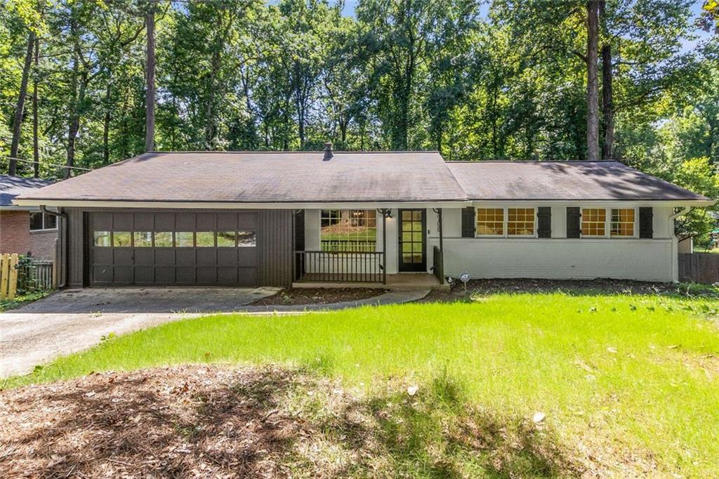 This beautifully renovated brick ranch in Montreal Woods offers a fantastic open and flowing floor plan with thoughtful design throughout. The spacious layout includes a private master suite wing with full ensuite bathroom, separated from the additional three bedrooms for added privacy. Enjoy a bright bonus sunroom that opens to a large back deck—perfect for entertaining or grilling. Inside, you'll find custom built-in shelving framing a cozy fireplace, fresh paint, and new floors. The fully renovated kitchen features new appliances, white cabinets, and granite countertops. Both bathrooms have been fully updated with stylish finishes. A large separate laundry room adds convenience, and the two-car garage provides plenty of storage. The open layout and well-defined spaces give this 2,311-square-foot home an even greater sense of size and comfort. Ideally located with convenient access to City of Tucker, City of Decatur, and Northlake, with quick access to Hwy 78, I-285, and Lawrenceville Hwy—this one checks every box!
