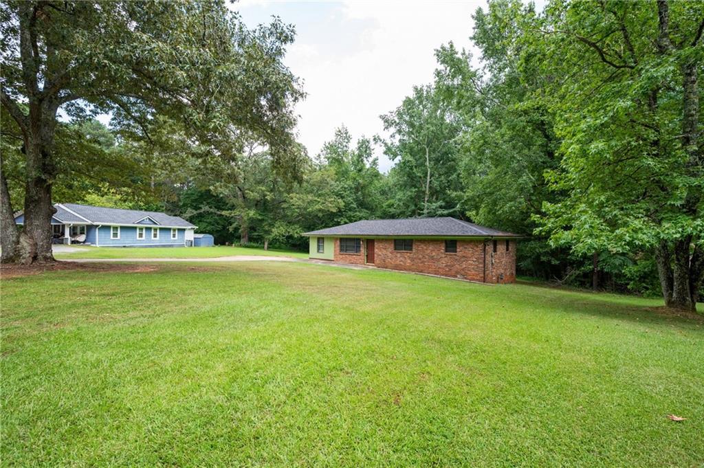 Welcome to the heart of South Fulton! This charming three-bedroom, single-floor residence offers an updated kitchen and bath, complemented by gleaming hardwood floors that flow throughout the home. The converted garage provides a spacious laundry room and versatile bonus space perfect for a home office, play area, or additional living quarters. Relax in the cozy den after a long day, or enjoy the gentle breeze on the inviting deck. With its solid four-sided brick construction and expansive lot of over 3/4 of an acre, this home is a true gem.
Ideal for first-time home buyers or families seeking a property with no HOA, and minutes from everything you need. Enjoy the convenience of being close to the airport and bustling Atlanta, with Camp Creek Marketplace just a quick seven-minute drive away. Whether you're starting a new chapter or down sizing, this home offers good bones and endless possibilities on its generous land. This one could even make a great income property such as AirBnB. Don't miss out—make your appointment today and discover why this is the perfect place to call home!