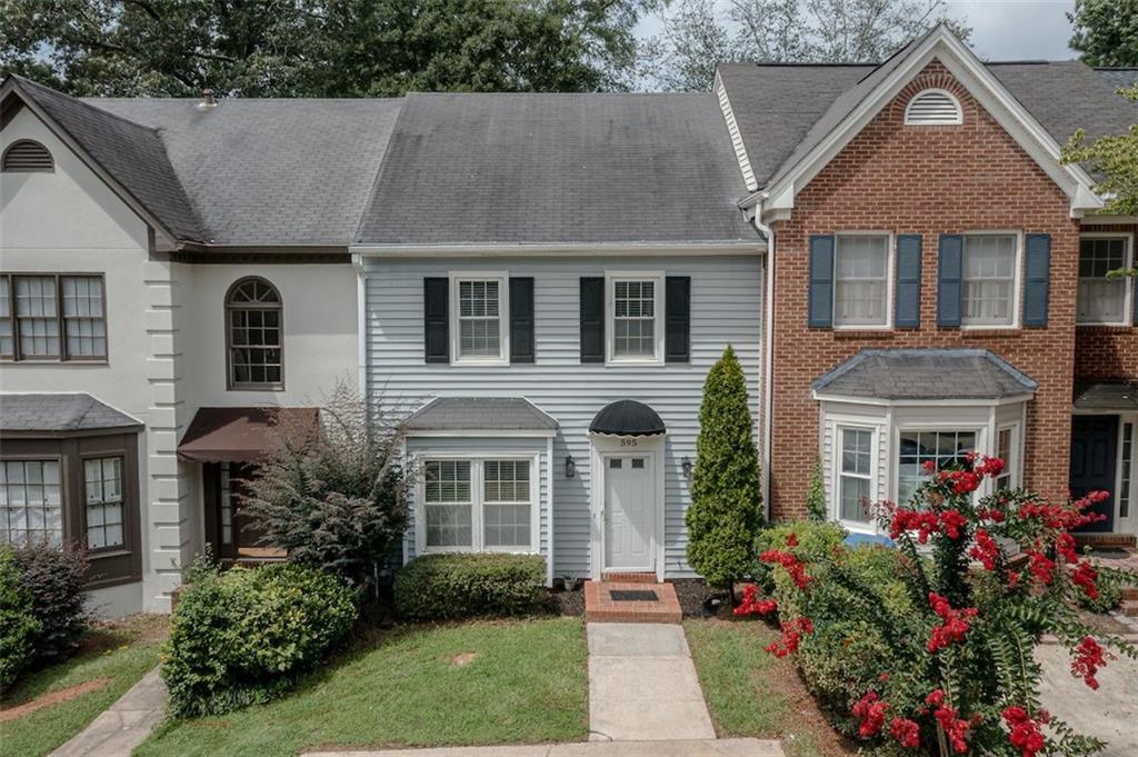 Welcome to this spacious townhouse located in the desirable Salem Woods community of East Cobb! This charming fee-simple community offers low association fees and move-in-ready features. As you enter the home, you will love the beautiful laminate wood flooring throughout, natural light from updated windows, and a relaxing backyard. The bathrooms and kitchen have been recently remodeled, adding a modern touch to this inviting space. The spacious living room with a cozy fireplace and dining room open concept leads to a private patio, perfect for outdoor entertaining. The dining room connects seamlessly to the galley-style kitchen with a breakfast area, and a convenient half bath is on the main level. Upstairs, you'll find two bedroom suites, each with a private ensuite bathroom and walk-in closets, along with a laundry room for added convenience. The property includes a driveway with parking for two cars, an attic that will surprise you, and a storage shed for extra storage in the backyard. Enjoy low-maintenance living minutes from I-75 and I-285 in the heart of shopping, entertainment, and a short drive from the Atlanta Braves Stadium. Don't miss this fantastic opportunity!