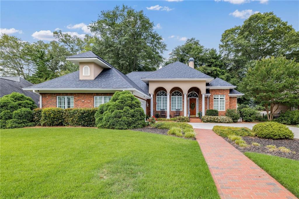 In The Heart of the City. All Brick Ranch Style Home with soaring 14'-16' Ceilings. Elegant upgrades throughout include Hardwood Flooring, Central Vac, Crown Molding, Tile Baths, and an enclosed Sun Room with a Gunite Swimming Pool for year around use. Enjoy city living with sidewalks and close enough to walk or take the Trolley to Restaurants, Parks, Tennis and Pickle Ball courts, Historic Green St., and the Gainesville Square.