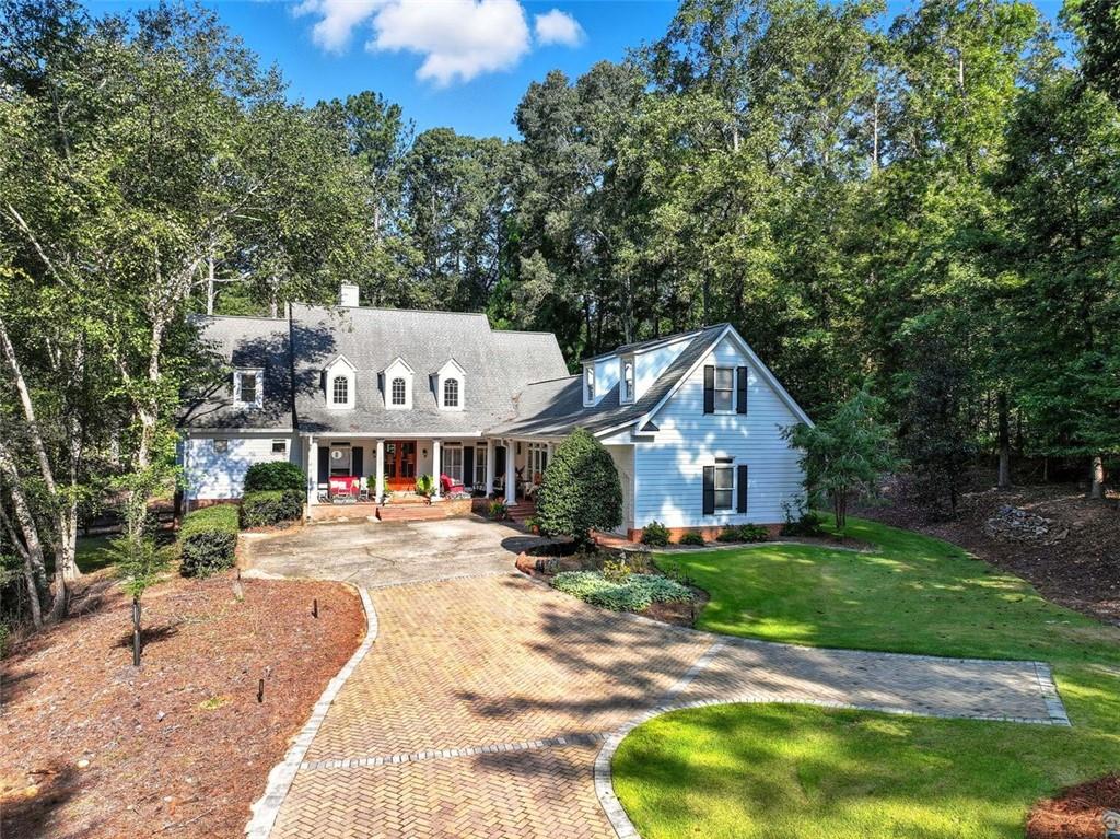 Welcoming cottage-style home with a charming rocking chair front porch on a quiet cul-de-sac and no HOA. Sitting on a beautiful, private lot, this property has been thoughtfully updated with a screened-in porch, new front stairs, new AC/furnace for upstairs with humidifier in basement, new sprinkler system, improved backyard drainage, new landscaping by the driveway, new plantation shutters and blinds, and fresh interior paint throughout (except master bedroom and bath). The exterior was painted just 3 years ago and features new gutters, gutter guards, and a fenced-in backyard.
Highlights of the open floor plan include hardwood floors on the main level, a vaulted fireside family room with three sets of French doors opening to the covered deck, and a granite chef’s kitchen with stainless steel appliances, island, breakfast area, and fireside keeping room with built-ins. The separate dining room is perfect for entertaining.
The master on main retreat features a sitting room, bamboo floors, and a luxe bathroom. Upstairs offers spacious secondary bedrooms plus a loft. The unfinished basement is ready for customization. The level backyard with private views makes this home ideal for relaxing or hosting gatherings.