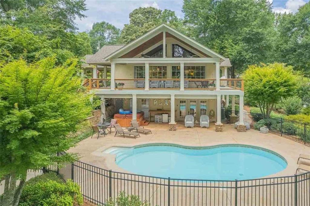 Lovely Lakefront Retreat with Breathtaking Views of Lake Hartwell. Welcome to this beautifully updated and spacious lakefront retreat on Lake Hartwell. With gorgeous open water views and luxury upgrades, this home is designed for comfort, style, and relaxed lakeside living. Step inside to find soaring vaulted wood ceilings and a wall of windows that showcase a view of the lake, private in-ground pool and gently sloping walk to the lake. The gourmet kitchen is spacious with beautiful countertops, upgraded appliances, and crisp white cabinetry, all open to the great room with a cozy gas log fireplace and a generous dining area-ideal for entertaining. The main-level primary suite is a private sanctuary with trey ceilings, a large walk-in closet, and a spa-like bath featuring a soaking tub, double vanities, and a separate tiled shower. A guest bath is also conveniently located on the main floor. Downstairs, the terrace level offers three additional bedrooms, a full bath, and a spacious second living area that opens to a covered patio and the kidney-shaped pool, all framed by a classic black iron fence overlooking the lake. Outdoor living is unmatched, with a balcony that spans the entire main floor, wrap-around porches, a second driveway with private basement entry, and mature landscaping all around. The recently installed new roof offers peace of mind, while the newly sodded backyard provides a lush, green landscape all year round. This is a yellow-lined property - there are no dock rights, however you can beach your boat for a day of play on the lake or kayaking. Full price offer includes most the furnishings/furniture if desired.