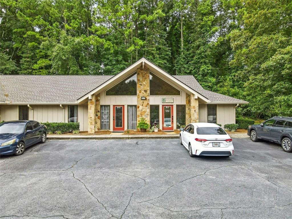 Professional office space in a convenient Roswell Location! This 1,026 SF unit offers a functional layout with 4 private offices, 2 updated bathrooms with newer vanities and flooring, and a kitchenette providing a perfect spot for a coffee station. A private front entrance opens to a spacious Reception/Waiting area with vaulted ceilings, creating a welcoming first impression for clients and guests. The suite includes 1 additional flexible room – suitable for a small workspace or easily converted to storage. Situated in Corporate Woods, a peaceful wooded office park off Elkins Road, the property offers a private and professional setting with convenient access to Holcomb Bridge Road, GA-400, and nearby dining and retail. The well-maintained complex features new roofs throughout and ample on-site parking. The office is currently leased to multiple tenants on month-to-month agreements. Tenants may be retained for investment income, or the space can be used for the owner’s business operations.