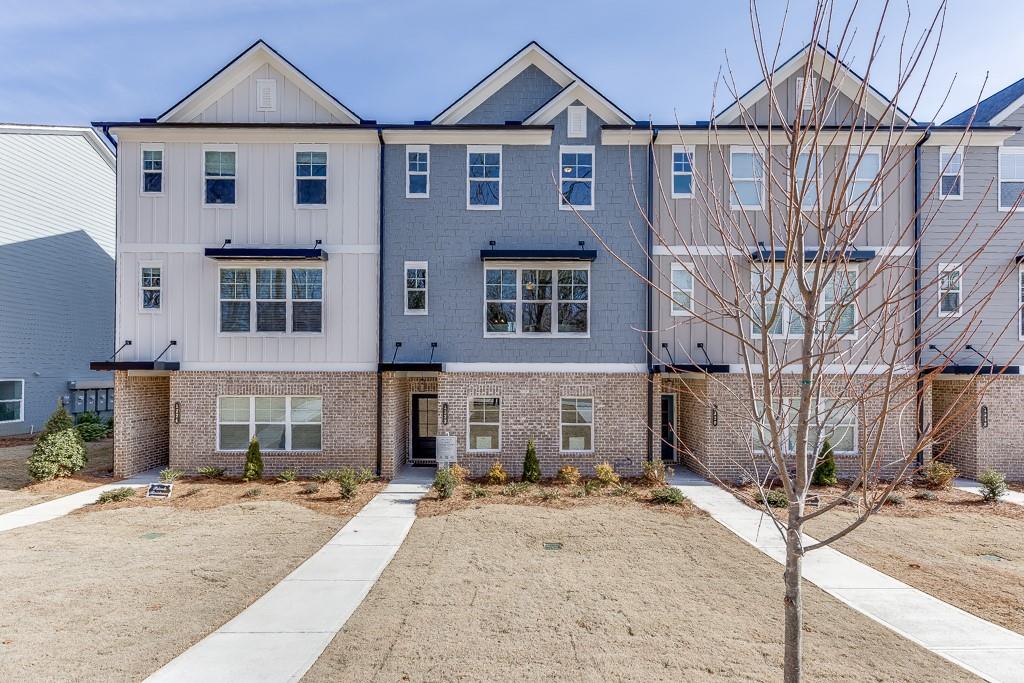 Lot 32. The Oakfield Plan. 3 story. New 3 Story Townhomes, Hillcrest Landing. Rear entry 2 car garage. Top of the line finishes including Revwood laminated wood flooring, tile, quartz & granite countertop options. The latest of trends in paint color selections, these homes will not disappoint. Located close to downtown Sugar Hill with local restaurants, boutiques, walking trails and entertainment at the Sugar Hill bowl and the Eagle theater plus the E Center a fabulous athletic center. Close to highways 985 and 400 and just minutes to Mall of Georgia. Interior and some exterior photos are stock photos of model home, not of actual home.
