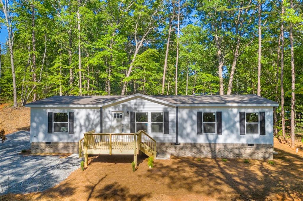 ***UPDATE*** Freshly paved expansive parking areas and driveway. Come and explore this delightful brand new North Georgia mountains home, boasting 3 bedrooms, 2 bathrooms, and an inviting open-floor plan. Situated on a 0.80 acre lot, this energy-efficient gem is located on a very private and quiet road with minimal traffic. This property has the feel of a rural setting, but sits only minutes away from historical downtown Clarkesville. This Energy Star Rated home boasts a full manufacturer’s warranty for one year, a lifetime warranty on siding, 20-year warranty on shingles, 7-year warranty on AC, and warranties on all new appliances and systems. Financing options include USDA 100% loans, FHA, VA, and all conventional loans. With so much to offer, this is a property you don't want to miss!