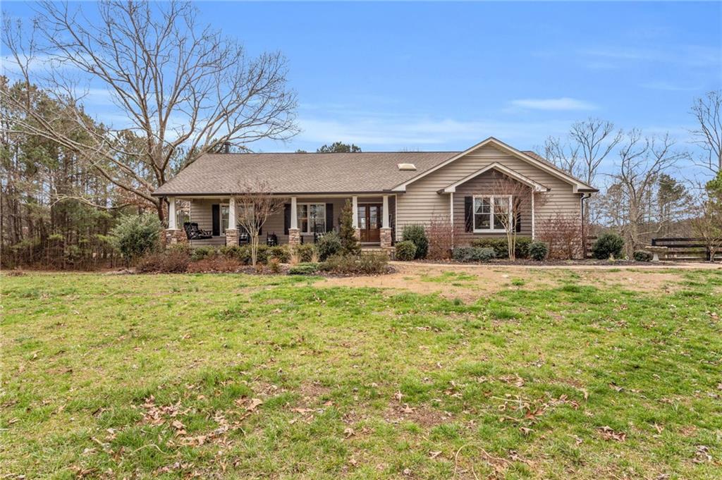 2.65 acres with a gorgeous craftsman style country home in Acworth! This is the best of both worlds, no HOA with room to garden, store your hobby vehicles and play! You are so close to town and yet you have all the perks the 2.65 acres brings. This lot boarders Patriots Park which means the county rec facilities are just a short walk away. From here you can easily access I-575 and I-75 making this location central for those that commute into the city. Inside you will be wowed by the detail that has been put into this home. The massive living room is fully open to the chef's kitchen. The layout of the kitchen is quite a sight with an adorable pantry with a custom wooden door, icemaker, wine chiller, double oven, stainless appliances, beautiful beams and tongue and groove ceilings. There is also a perfectly situated window seat that adds a touch of cozy to the space! The pictures are pretty awesome but you have to see this in person to really appreciate the attention to detail. The dining area and large island can accommodate 12+ people making this grand central station for entertaining. The double doors in the kitchen lead out to the back deck which allows for more entertaining space. The other side of the home is where the master suite, two secondary bedrooms and a full bath are located. Downstairs is a full bathroom with a living room, large bedroom with an extended suite area and additional flex room that could be a bedroom, office or room to build out a second kitchen. There is exterior access via double doors that lead to an outdoor seating area. The back yard is private and quiet, you'd never know the main road is nearby. You will notice a quaint playhouse and an outbuilding with two sided lean-tos for covered storage. Bring your boats, campers, trailers, etc. See the documents for aerial views and more information.