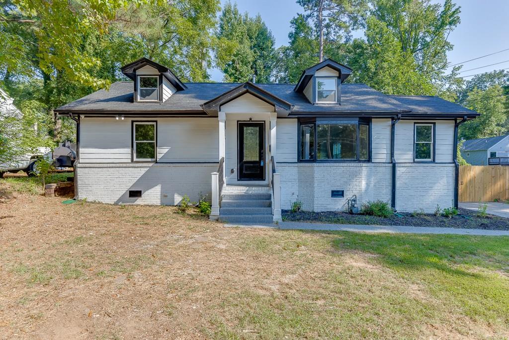 COMPLETELY RENOVATED home in Oakland City that is MOVE IN READY. This open concept ranch has been updated and upgraded to look and feel like new! Walls have been taken down, the kitchen has been relocated and the floorplan has been opened up completely through the main living areas. New roof and exterior paint. New front door with decorative privacy glass insert. New privacy fence. Beautiful bay window in the living room allows the sunlight to flow in. New LVP floors, carpet, paint and light fixtures. Kitchen with brand new white cabinets and contrasting stained island with quartz countertops and on trend matte black hardware, lighting and plumbing fixtures. Relax in the newly added sunroom on the back of the home which adds additional light and has increased the square footage of the original living area. The primary suite has a closet with a custom barn door and a gorgeous spa like bathroom, fully tiled, with a huge shower with both a rain head and wall multi shower head system and built in bench. Double vanity with quartz countertop accented by decorative mirrors. Seperate water closet for privacy. Two additional bedrooms share a second bathroom that has a tub/shower combo with glass doors, upgraded tile to the ceiling and a built in niche. Quartz countertop and decorative mirror. Laundry room on the main with LVP and a new water heater. Huge deck off of the side of the home allows for grilling and outdoor entertaining. Flat back yard is perfect for a future garden oasis. Long driveway offers ample room for homeowner and guest parking with a front yard wooden privacy fence and double gate to open up for driveway/front yard access to the back yard. Great location close to the Westside beltline, Lee + White development and Marta.