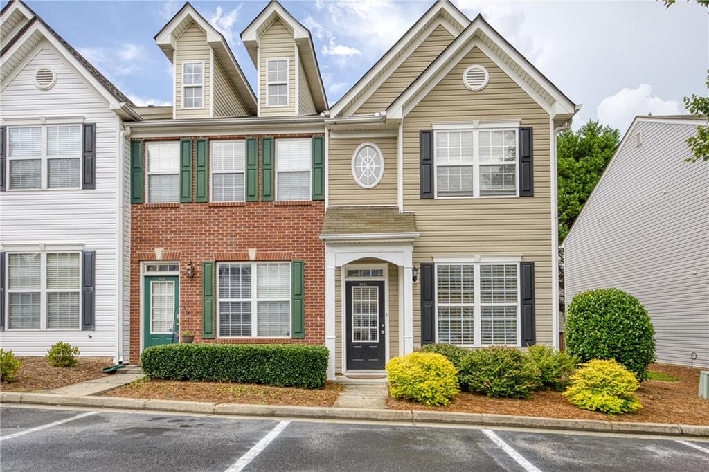Welcome to this charming end-unit townhome featuring two private en-suites in a swim and fitness community. Perfectly located near reputable schools, just minutes from I-85, and close to healthcare, shopping, dining, and entertainment, including Sugarloaf Mills. Outdoor enthusiasts will love being near Collins Hill Park, Suwanee Creek, and Peachtree Ridge Park with miles of scenic trails and recreational opportunities. Enjoy a covered front entry that leads into a tiled foyer and a flexible dining room that could easily serve as a home office. Peninsula-style kitchen, complete with a breakfast bar, stainless steel appliances, and generous counter space for meal prep and entertaining with an effortless flow into the family room featuring a cozy wood-burning fireplace. Upstairs, the vaulted primary suite has been thoughtfully updated with new ceramic tile, a walk-in shower, and a free-standing soaking tub, creating a spa-like retreat at your fingertips. A second en-suite bedroom provides flexibility and privacy for guests or roommates. Step outside to a private deck with wooded views, ideal for relaxing, grilling, or dining under the stars. A convenient outdoor storage room offers space for your grill, tools, and seasonal décor. Water, trash, fitness center, and pool access are all included, offering both value and convenience in this well-maintained community.