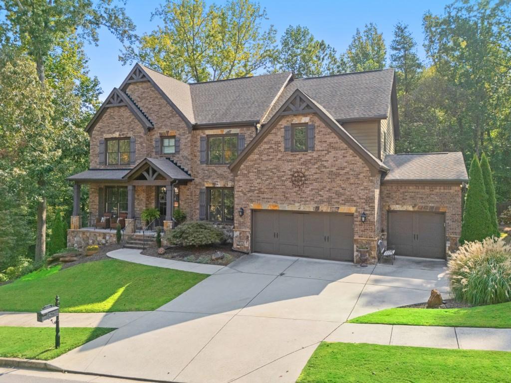 **Welcome Home to Exceptional Living in Ashbury Park**Set within the prestigious Mill Creek School District, this exquisite 5-bedroom, 4-bathroom home perfectly balances timeless elegance with everyday comfort in the desirable swim and tennis community. From the moment you arrive, the inviting front porch and impressive double-door entry welcome you into a soaring two-story foyer, setting the stage for the refined craftsmanship found throughout. Newly refinished hardwood floors, rich custom millwork, and streams of natural light create a warm yet sophisticated atmosphere across the main level. Thoughtfully designed living spaces include a formal dining room, a quiet home office or library, and a guest suite with a full bath ideal for hosting overnight visitors or multigenerational living. At the heart of the home, the stunning two-story great room makes a statement with dramatic coffered ceilings, a stately stone fireplace, and custom built-ins all framed by expansive windows with tranquil views of the wooded backyard. The open-concept gourmet kitchen is a true showstopper, boasting crisp white cabinetry, elegant stone countertops, a charming window over the sink, and seamless flow into the great room and covered porch the perfect spot for your morning coffee or winding down in the evening. Upstairs, the luxurious primary suite offers a peaceful retreat, complete with a cozy sitting area, a spacious spa-inspired bath, and a generous walk-in closet. Three additional bedrooms share a well-appointed bath, while a dedicated media room is ready for movie night or game-day gatherings. The unfinished walk-out basement presents endless possibilities for customization, and opens to your very own backyard oasis a private, wooded sanctuary overlooking a serene pond. Whether it's casting a line in the pond at sunset or roasting smores under the stars, this backyard was made for memories. With unmatched style, functionality, and a prime location, this home truly offers the best of Ashbury Park living. Your next chapter begins here. Don't let it pass you by.