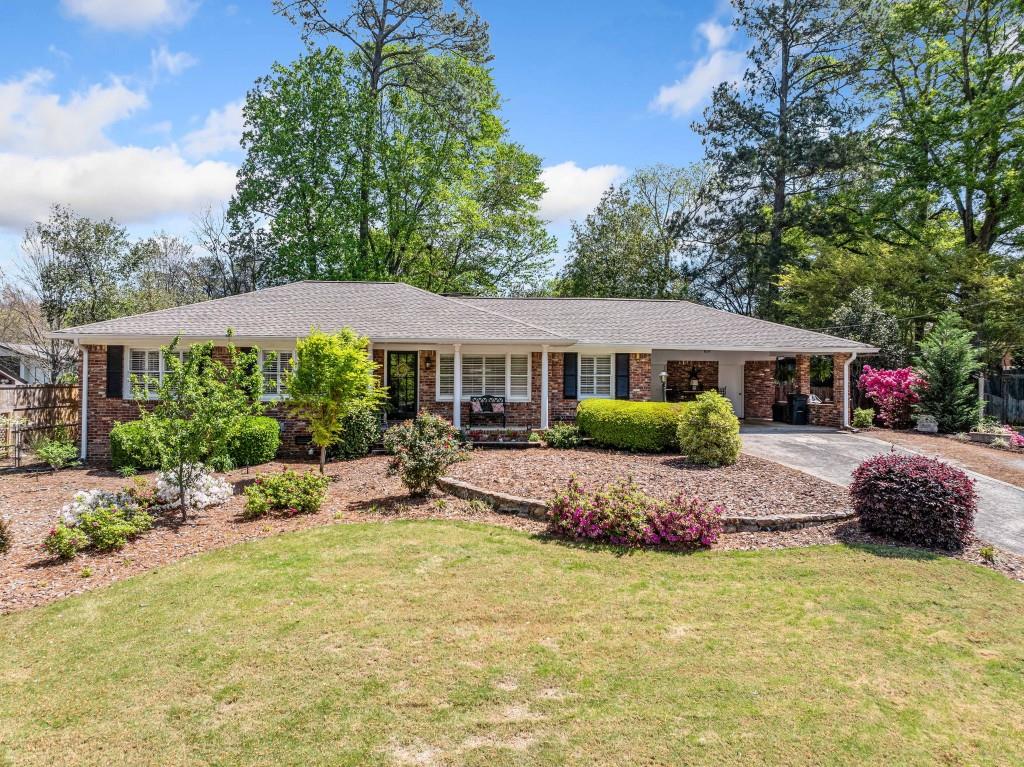 Updated Brick Ranch in East Cobb Swim Tennis Community! Welcome to your Dream Home in Marietta. Nestled in a Quiet Subdivision, yet just minutes from Shopping, Top-Rated Schools, and Major Highways, this beautifully renovated home offers the perfect mix of Tranquility and Convenience. Situated on a gentle hill, this home greets you with a Charming Covered Front Patio and Gorgeous Natural Light that pours in through the large front windows, accentuated by Classic Plantation Shutters that add both style and privacy. Step inside to find Gorgeous Hardwood Floors, Crown Molding, and an Open Concept Living and Dining Room ideal for entertaining. Don't miss the stylish Accent Doors connecting the Dining Room to the Hallway, adding character and architectural interest to the flow of the home. The Updated Kitchen features Granite Countertops, White Cabinets to the Ceiling, Stainless Steel Appliances, and a Sleek White Subway Tile Backsplash. Relax in the Fireside Family Room with a stunning Floor-to-Ceiling Brick Fireplace, or head into the Expansive Sunroom the true Heart of the Home. With exposed Brick Details and Tons of Windows, this light-filled space is perfect for Entertaining, Game Days, or simply enjoying your morning coffee. A Dedicated Office Space provides the perfect setup for Working From Home or Homework Time. The Primary Bedroom is a peaceful retreat featuring an Updated Ensuite Bathroom with Marble Countertops, a Sleek Tiled Shower, and a Large Walk-In Closet. Two additional Generously Sized Bedrooms and Two Full Bathrooms offer plenty of room for guests or family. Outside, enjoy the Private, Fenced-In Backyard from your Back Patio ideal for Grilling, Gardening, or cozy nights by the Fire Pit. The elevated lot offers a sense of seclusion and serenity, enhanced by the surrounding landscaping. A Storage Shed adds convenience for outdoor tools and toys. Located in a Lovely Neighborhood with easy access to I-75, I-285, Sandy Springs, and Downtown Atlanta. Enjoy nearby Shopping, Dining, and Terrell Mill Park just one block away. Optional HOA & Swim Tennis available. Peaceful, wide neighborhood streets make it the perfect place for evening strolls, morning runs, or walking the dog. Don't miss your chance to enjoy Comfortable Ranch Living in one of East Cobb's Most Convenient and Coveted Communities!