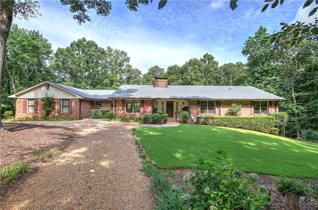 They don’t make them like this anymore! Custom Built in 1977 with custom cabinetry throughout, custom built-ins, and gorgeous wide plank wood flooring throughout. Beautiful sprawling RANCH home over basement. This home has privacy that is hard to find in the city limits, with the home sitting on 1.03 acres and includes the approx. 1.28 acre wooded lot next door. Located in the heart of Cartersville in the highly sought-after, Conyers Estates neighborhood. The home is over 2900 square feet on main level, plus a 1200+ daylight basement with entry (basement is framed and rough bathroom plumbing in place). This home offers ample room for both everyday living and for entertaining, with large rooms and a large outdoor patio with stream water feature and surrounded by well-maintained wooded area or enjoy the views from the comfort of the heated/cooled sunroom. Nestled within the top-rated Cartersville City School District and just a 3-minute ride to historic downtown Cartersville and 4.5 miles to I75. A large main suite with walk in closet, and 2 additional bedrooms and 2.5 baths there is plenty of room for expanding families or home offices. The expansive basement boasts an additional 1200+ square feet of usable square footage, offering even more room to expand, whether for a home theater, gym, additional bedrooms, room to entertain or could easily be finished and converted into a separate income producing property or in-Law suite. Located in a peaceful, established neighborhood, this "Quintessential Cartersville" home is your ideal forever home, providing comfort, style, and plenty of space for your family to grow. Don’t miss your chance to own this exceptional, one-of-a-kind property—schedule a tour today! Lot 109 Tanglewood, Parcel: C038-0001-006 can be purchased separately.