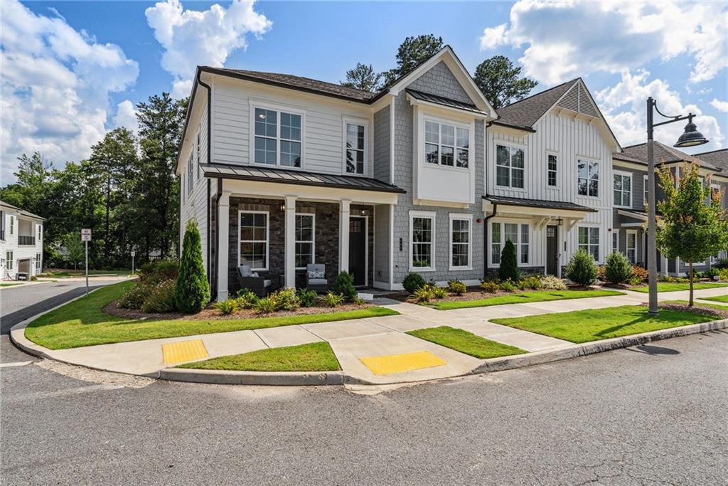 Welcome to Ruisseau -- Where modern luxury meets everyday ease in the heart of downtown Woodstock. This stunning end-unit townhome served as the community's model home and is a rare find with all of the gorgeous features and upgrades that are included! The light and bright open-concept main level is ideal for entertaining and showcases a gourmet kitchen with a full suite of stainless steel appliances + an oversized island with waterfall countertops that overlooks a warm and inviting great room with gorgeous built-in bookshelves and cabinets that creates the perfect focal point around the beautiful gas fireplace. Your luxurious primary suite is conveniently located on the main floor and features a walk-in shower with bench; generous walk-in closet with custom shelving; and refined fixtures and finishes that elevate everyday living. An additional flex room on the main level features tons of natural light and offers endless possibilities as a home office, library, or creative retreat. Upstairs, two oversized secondary bedrooms each include their own ensuite bathroom and a walk-in closet —perfect for family, guests, or multi-generational living. The large loft also creates another comfortable entertainment space for movie nights, game days, or quiet escapes. Another one of the standout features of this home is the remarkable 450+ sq ft of untapped potential for additional finished living space. Or if storage is more of what you're looking for, this is definitely the ideal space for easy-to-get-to storage without having to go up an attic ladder! Enjoy the charm of a community that features shared outdoor spaces including a pavilion, firepit, grilling area, and bocce ball court. You'll love grabbing gelato at Dulce just around the corner, and with the vibrant energy of Downtown Woodstock’s restaurants, breweries, shops, and festivals just a walk, bike ride, or golf cart cruise away, Ruisseau brings you the lifestyle, low-maintenance living, and modern luxury you're looking for in your new home!