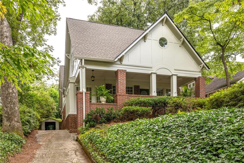 Some homes are built to impress. Others are built to live in. This one does both - with grace, light, and historic charm.
This classic Morningside Tudor combines original vintage character with a fresh, modern sensibility. Perfectly placed on one of the neighborhood’s most beloved streets, this sun-drenched, character-filled home blends timeless architecture with smart, stylish updates throughout. Originally designed by Lelia Ross Wilburn – Atlanta’s first female architect – its thoughtful layout, rich detailing, and beautiful proportions still shine, now paired with a long list of functional upgrades that make everyday living feel easy.
A deep, breezy front porch sets the tone, complete with multiple seating areas for those summer nights and neighborly conversations. Inside, the main level opens with a formal living room and picture molding details that whisper back to the home’s heritage. A cozy sunroom wrapped in floor-to-ceiling windows makes the perfect reading nook or creative corner, while a separate dining room and light-filled breakfast nook offer space for both everyday meals and full-on dinner parties.
The heart of the home is a large, open living space at the back, where French doors open to a walkout backyard, ideal for outdoor hangs, easy hosting, or simply enjoying some sunshine. Also on the main level is a private guest suite with a fireplace and full bath, ideal for visiting family, live-in assistance, or that home office that finally gets some dignity.
Upstairs, the landing opens to a flexible lounge space – think reading area or a cozy second den. The primary suite is a true retreat, with natural light, beautiful views, a spacious walk-in closet, and an ensuite bath complete with a cast iron soaking tub, dual vanities and a separate shower. Two generously sized secondary bedrooms each feature large closets and share access to a sunny bonus room that works hard for whatever you need. A dual-sink hall bath adds function and shareability, and in its own private space windows make even laundry feel luxurious.
This is the kind of home that evolves with your life—offering character, comfort, and the kind of layout that just works. And with its location in the heart of Morningside, you’re just moments from parks, shops, restaurants, and everything that makes this neighborhood one of Atlanta’s most beloved.