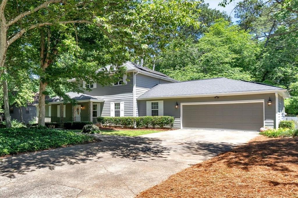 Flexible Living in Prime East Cobb Location! This home offers a rare and versatile floorplan with endless possibilities. The unique layout features 3 separate living areas, each with its own kitchen. The left side of the home functions as a self-contained Accessory Dwelling Unit (ADU). It has a private entrance through the front foyer and a separate side door entrance into the basement living area. The main living area boasts an open-concept great room and dining room with a fireplace and built-in bookcases. Upstairs, 3 bedrooms including a primary suite with private bathroom and tiled walk-in shower. Down the upstairs hallway are two other bedrooms with a shared bathroom. Downstairs, the basement has an additional private entrance, a kitchen, and two living spaces. This lower level is ideal for multi-generational living or generating rental income. Throughout the home, you'll find thoughtful details like updated lighting, doorknobs, newer water heaters and HVAC systems. The solar panels provide great savings to the electric bill. Outside, a large deck overlooks a private saltwater pool, surrounded by easy-to-maintain landscaping. Enjoy the shade of the trees or soak up the sun. Free from HOA restrictions, this unique property offers endless possibilities for the growing family, in-laws or savvy investor. The homeowners have maintained and upgraded numerous aspects of the property. You can find a comprehensive list of more improvements/upgrades in the photo section.