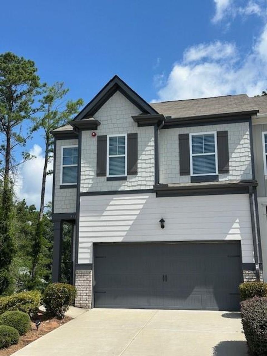 Highly Sought-After Stratford Floorplan – End Unit Townhome with Finished Basement! Move-in ready and beautifully upgraded, this end-unit Stratford townhome offers the perfect combination of style, space, and convenience. The versatile partially finished basement with a full bath provides endless possibilities—ideal for a media room, guest or teen suite, home office, or gym. Step inside and you’ll find luxury vinyl plank (LVP) flooring throughout the main and upper levels, plush carpet in the basement, and fresh paint throughout. The main level features 9-foot ceilings and a stylish kitchen with STONE GRAY cabinetry, granite countertops, subway tile backsplash, pendant lighting, and a large center island—perfect for entertaining. The kitchen flows seamlessly into a spacious great room with a gas fireplace and a casual dining area that opens to a freshly stained back deck—ideal for relaxing or hosting guests. The stainless steel appliance package includes a gas Whirlpool range, dishwasher, microwave, and a Samsung 4-door French Door refrigerator. Upstairs, the primary suite is a true retreat, featuring a tray ceiling, custom walk-in closet with built-ins, and a deluxe en-suite bath with dual granite vanities, a soaking tub, and a separate shower. Two large secondary bedrooms include ceiling fans; one features a walk-in closet and cozy reading nook. The laundry room offers custom shelving and hanging space for added convenience. The partially finished basement opens to a private, fenced backyard—perfect for pets or outdoor enjoyment—and provides ample unfinished storage for seasonal items. Additional upgrades include smart thermostats and a security system. Unbeatable location—just 2 miles from I-575 and Downtown Woodstock, with easy access to Roswell. Enjoy the community pool and cabana, just a short walk away, plus ample guest parking right outside your door. The HOA includes: front and backyard landscape maintenance, community amenities, trash and recycling, termite bond, and exterior maintenance (including roof and paint). Don’t miss your chance to own one of the most desirable floorplans in an exceptional location!