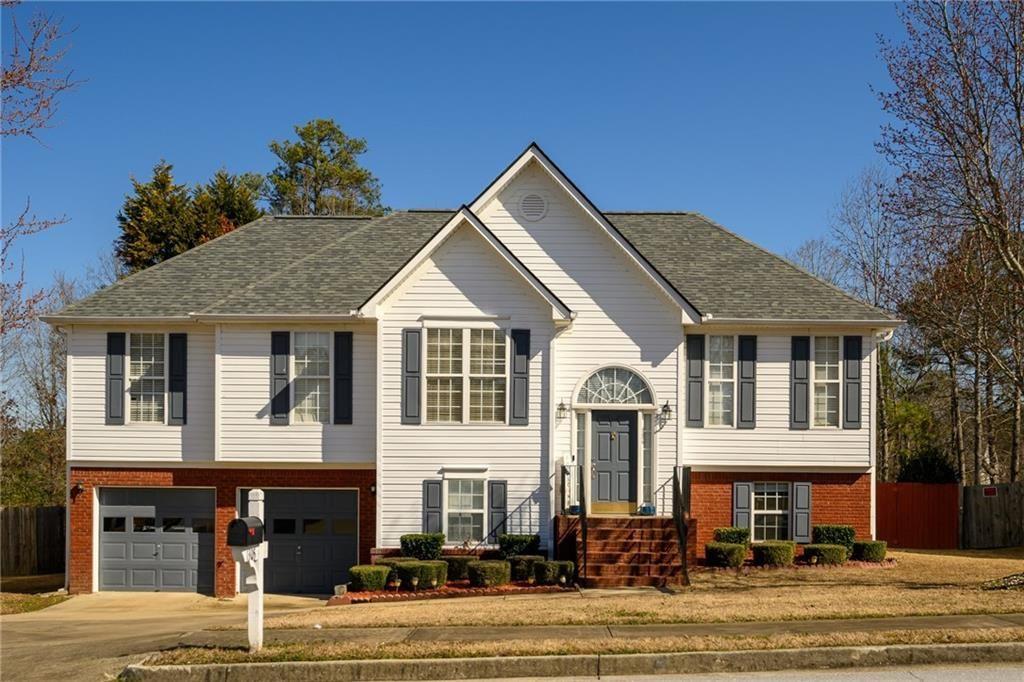 This stunning home is ready for you to move in and start making memories. Imagine whipping up culinary masterpieces in the gourmet kitchen, featuring sleek Samsung stainless steel appliances and granite countertops. Enjoy soft-close drawers and cabinets for added convenience, and an open-concept layout that seamlessly connects to the inviting family room with its vaulted ceiling and cozy fireplace. This home is packed with upgrades: Spacious kitchen pantry for all your culinary needs. Formal dining room with elegant French doors for special occasions. Warm bamboo floors throughout the main level for easy cleaning and stylish charm. Master bath oasis with dual vanities, separate soaking tub and shower, and a walk-in closet with a built-in storage system. Finished lower level offering a bedroom, bathroom, and a huge media/living/office combo space - perfect for entertaining or relaxing. Step outside and enjoy the large fenced backyard, perfect for barbecues and family fun. Need to escape the sun? Double French doors lead to an oversized concrete pad for shaded relaxation. Plus, extra storage space in the garage. Newer roof, put on in 2020. The community also offers: Swimming pool and 4 tennis courts for active lifestyles. Convenient location near major highways and parks. Close proximity to downtown Lawrenceville with its shops, restaurants. Don't wait for this opportunity to fumble away! Schedule your showing today and score your dream home!