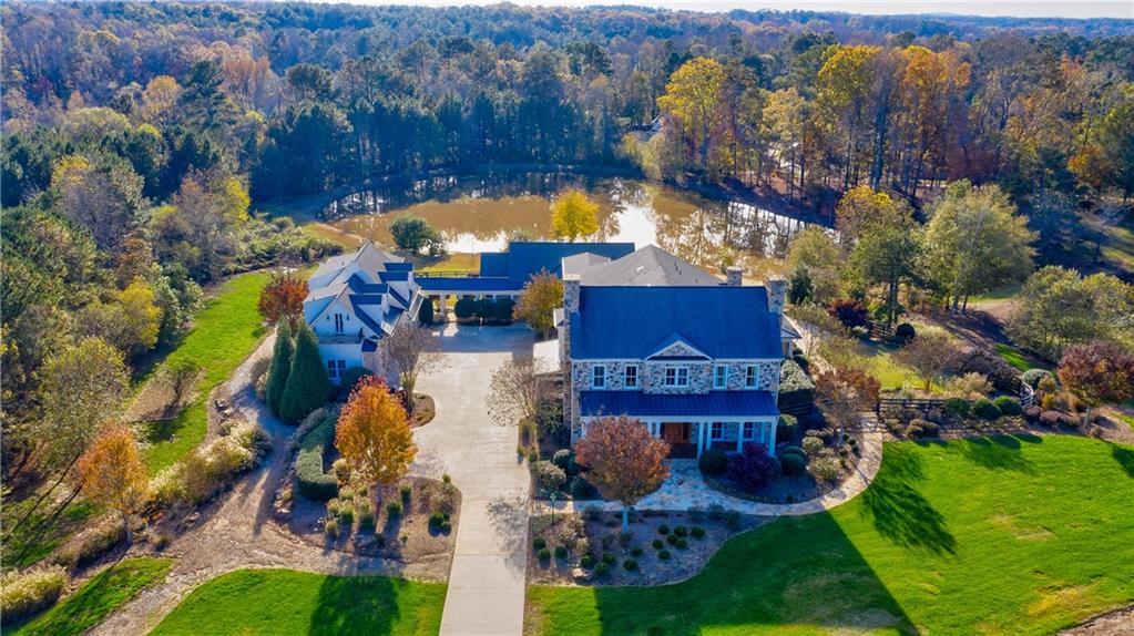 Beautiful state of the art equestrian estate awaits you in Milton! 22 gated acres close to downtown Alpharetta! Custom Home. Master on main, Chefs Dream Kitchen. Spectacular infinity edge pool, Spa,screen porch, fire pit, two ponds. Finished terrace w/media room, exercise room, family room, bar, wine room & safe room. Dream barn w/five stalls, climatized tack room, wash rack,apartment w/stone FP, beams, kitchen & bath. Plush green pastures, trails & arena. Control 4 Smart Home Automation System controls security, lighting, entertainment & energy, from your phone!