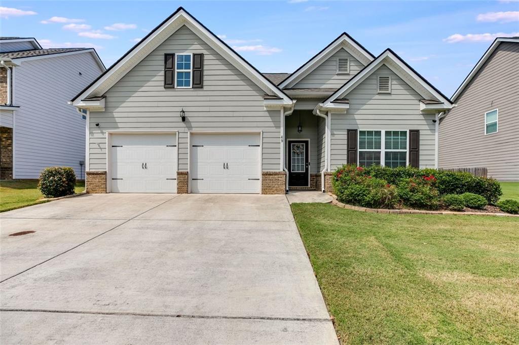 Welcome to this beautifully maintained single-story home that blends comfort, style and convenience. From the moment you arrive, the home's curb appeal sets the tone with its manicured landscaping, dual garage with auto openers and charming front entry. Inside the home opens to a bright and welcoming foyer with crisp trim work and durable flooring that flows seamlessly throughout the main living areas. A versatile front room offers the perfect space for a guest bedroom, office or hobby room, filled with natural light through large windows. The open-concept layout makes everyday living and entertaining effortless. The dining room features elegant coffered ceilings and room for gathering. The spacious living room centers around a cozy fireplace, ideal for relaxing evenings and connects easily to the modern kitchen. Here you'll find upgraded stainless appliances, granite countertops and a bar with extra seating and cabinets that makes this space as functional as it is attractive. The primary suite is a peaceful retreat with tray ceilings, ample space for larger furniture and an ensuite bath that feels spa-like with its double vanity, full wall mirror, tiled walk-in shower with seating and generous walk-in closet space. Secondary bedrooms and bathroom are thoughtfully designed, ensuring both comfort and privacy in the spacious accomodations. Every detail of the home has been cared for, making it move in ready. Step outside into the fenced backyard where there is room for pets, play or a nice garden. The extended concrete patio allows space for enjoying a cookout or s'mores under the stars. The wood privacy fence encloses the whole back yard allowing for privacy and double gates allow access on both sides of the home. It is important to note that the two attached TV's and camera system are staying in the home as well as the refrigerator, washer and dryer. The community offers a clubhouse, inground pool and playground and is just minutes from shopping, schools, medical facilities and I-75 makes this a prime location