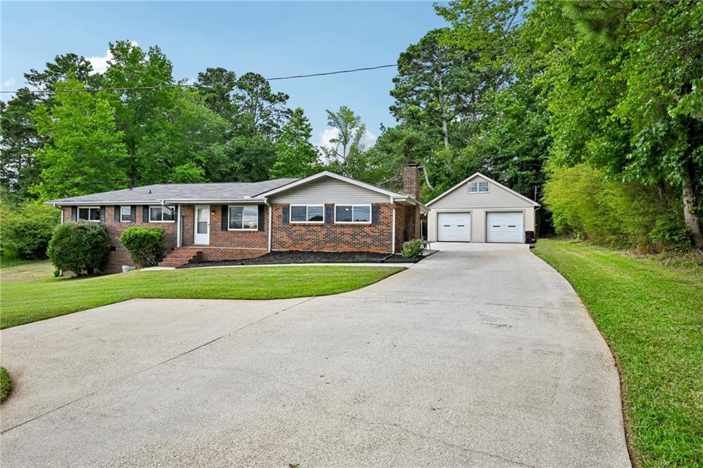 Bundled service pricing available for buyers! Connect with the listing agent for details. Welcome home to this fully updated 4-sided brick, 3-bedroom, ranch situated on a generous, private lot in Douglasville. Move-in ready with major updates already done, this home offers a perfect blend of modern upgrades and classic charm.
Step inside to discover new flooring throughout, fresh exterior doors, updated bathrooms, and brand-new energy-efficient windows that flood the space with natural light. The formal living room welcomes you in and flows effortlessly into a cozy fireside family room—ideal for relaxing evenings or entertaining guests.
The beautifully remodeled kitchen features granite countertops, sleek white cabinets, and stainless steel appliances.
Enjoy peace of mind with a new roof, new HVAC system, and new hot water heater, ensuring years of low-maintenance living.
Outside, a spacious deck overlooks the expansive backyard—perfect for summer gatherings or quiet mornings. The detached 2-car garage is more than just parking—it’s equipped with electricity, a half bath, and an unfinished upstairs loft, making it a flexible space ideal for a workshop, gym, man-cave, game room, or even a future rental/ADU conversion. In addition to generous storage and workspace, the shop is fully equipped with a 220-volt electrical line, ideal for powering heavy-duty tools, welders, or EV chargers. A dedicated water spout in the garage offers convenient access for car washing, detailing, and routine maintenance—a rare and valuable feature for auto enthusiasts or hobbyists.
Additional highlights include no HOA, tons of parking, and quick access to I-20, shopping, and schools.
This move-in ready home offers the comfort, flexibility, and convenience you've been searching for. Don’t miss out—schedule your showing today!