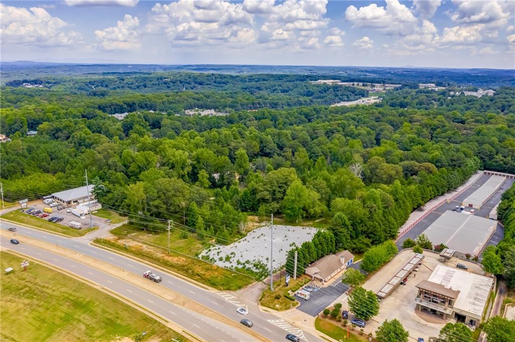 Beautifully level lot with Approx 35,000 square feet on Bells Ferry Road, Next door to Kaotic Kustoms Motorcycle shop at end of Eagle Drive. Old Mobile home park that has been cleared. All utilities available. No Structure on property. Mixed use/commercial development opportunities.