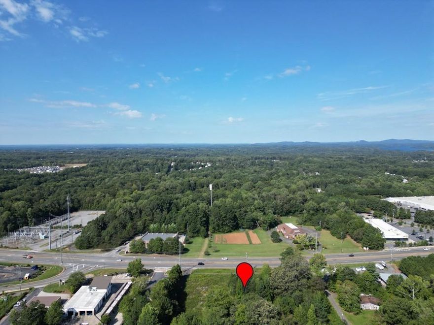 Beautifully level lot with Approximately 35,000 square feet, 3.04-acre commercial parcel offers high visibility and access on Bells Ferry Road at the end of Eagle Drive. Perfect for retail, office, or service business use. Owner is willing to divide the total 6.04 acre parcel for partial residential (FMLS 7649725) 3 acres and partial commercial 3.04 acres. All utilities available. No Structure on property. Mixed use/commercial development opportunities.