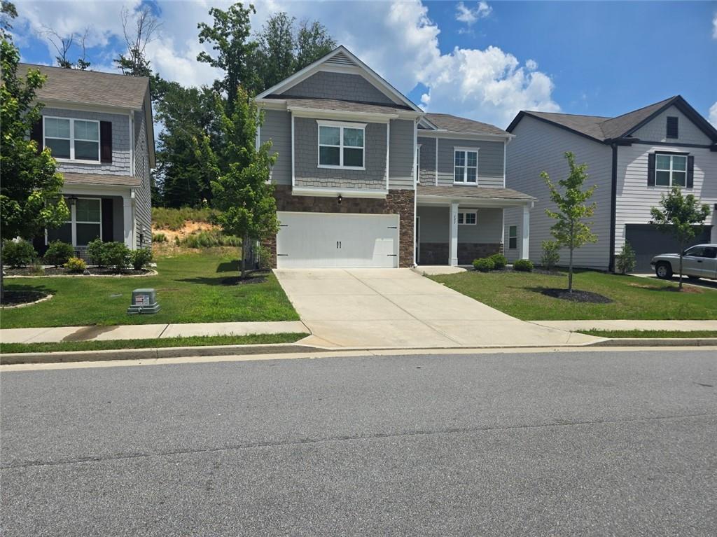 Two-story home with a light gray siding exterior and white trim