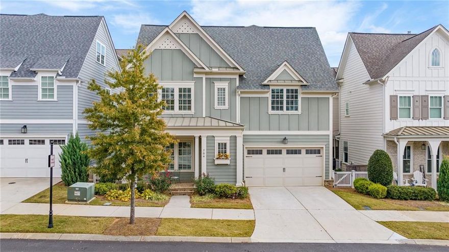 Set in the heart of South on Main, this three-story paired home blends everyday comfort with thoughtful design. Part of the John Wieland Collection, it offers the space of a single-family home with the convenience of full exterior maintenance handled by the HOA.

Inside, the home feels like new. Hardwood floors run throughout the main level, where a bright entry foyer with shiplap detail opens to a spacious living area anchored by a gas fireplace and built-in shelving. The eat-in kitchen features a gas range, stainless steel appliances, and abundant cabinetry, making both daily meals and entertaining effortless. A mud room with a half bath adds convenience and functionality.

Step outside to a private, low-maintenance retreat. The patio overlooks professionally installed artificial turf that stays green and perfect year-round.

Upstairs, the second floor includes three bedrooms and two full bathrooms. The primary suite offers two walk-in closets and a spa-style bath, while the second bedroom, accessed through a sliding barn door, provides a quiet, flexible space ideal as a guest room or home office. A third bedroom and an additional full bath complete the level, along with a well-appointed laundry room featuring built-in storage and a sink.

The third floor adds even more versatility with a large bonus room perfect for a home theater, playroom, or creative studio, plus a separate guest bedroom with a full bath.

South on Main offers resort-style amenities including a pool and clubhouse, community garden, firepit, amphitheater, dog parks, fitness center, playground, and direct access to Noonday Creek Trail, connecting you to over 60 miles of scenic paths. Downtown Woodstock is just a short stroll or golf cart ride away, with restaurants, shopping, breweries, and year-round events like the Summer Concert Series, festivals, parades, and seasonal Farmers Markets.