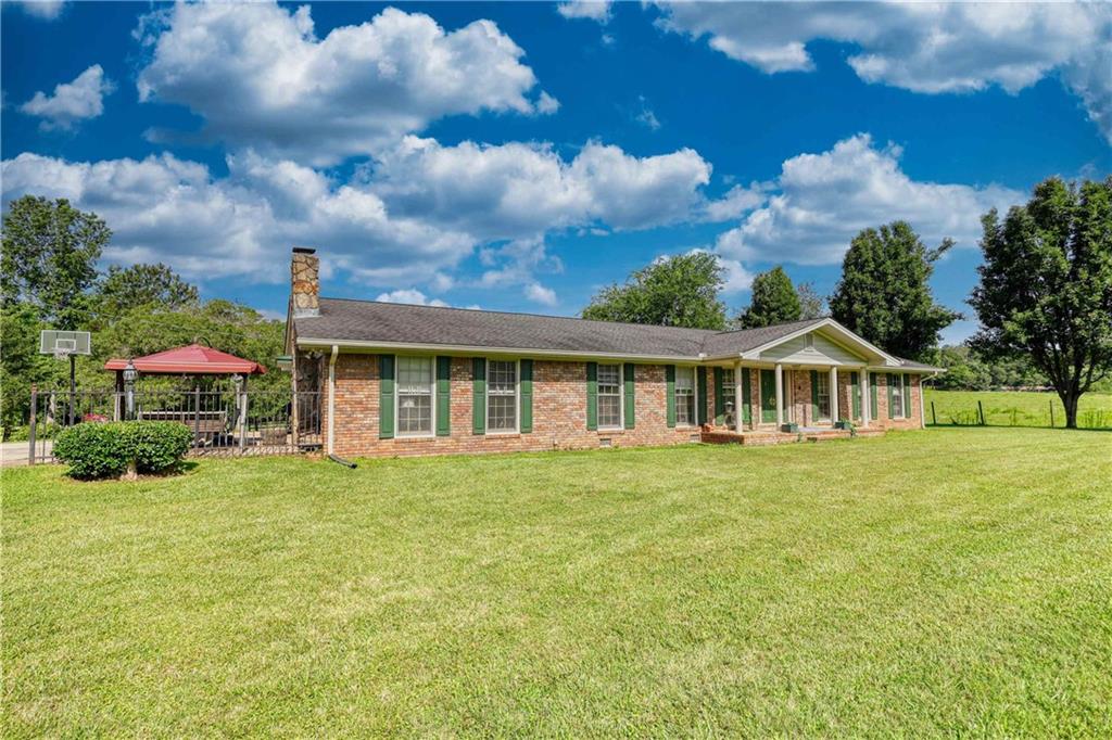 Discover the perfect blend of peaceful country living and modern convenience with this charming brick ranch nestled on 18.52 acres in beautiful Oxford, GA. Whether you're dreaming of a mini farm, a private homestead, or simply room to roam, this property offers endless possibilities. This home offers a traditional ranch layout with 3 bedrooms, 2 full (updated) bathrooms and plenty of space for hosting family and friends! Property also includes a 24x24 , 2 bay workshop and a fully stocked, spring fed pond. Enjoy the serenity of country living without sacrificing location, being only minutes away from shopping, dining and schools. Convenient access to Covington, Loganville, and I-20. Schedule your showing today and make this tranquil escape your forever home!