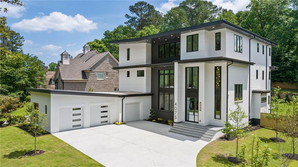 A rare opportunity for unique and modern luxury arrives in Buckhead by WilliamMarkDesigns. This custom new construction home will come with all the bells and whistles. The steel door reveals an open three story entryway and stairway featuring customized herringbone style hardwood patterns, and light shines through a stunning aluminum clad window package from floor-to-ceiling. Custom European flat panel cabinetry, subzero/wolf appliances and quartzite countertops highlight a breathtaking kitchen in addition to a private scullery combined with generous pantry space. All the little details prevail throughout with a massive master suite containing separate floating vanities and a custom oversized closet. All bathrooms include floor-to-ceiling tile as well bringing a true sense of elevated craftsmanship from the developer. A carefully thought out 3rd level features a private rooftop terrace with wet bar and an outdoor area to enjoy a glass of wine or host your closet friends. There's also an option to add a grilling station and beverage center. The property is pre-wired at every corner including all windows for future custom shades or blinds, and even includes an elevator to all 3 levels. The flat back yard comes with plenty of space, a beautiful custom pool with hot tub, pre-wiring for sound, and an outdoor kitchen/grilling station. Come see the latest in modern luxury design at one of the most cutting edge luxury properties in Buckhead. Luxury listing by WG - Wieloch | Goldstein.