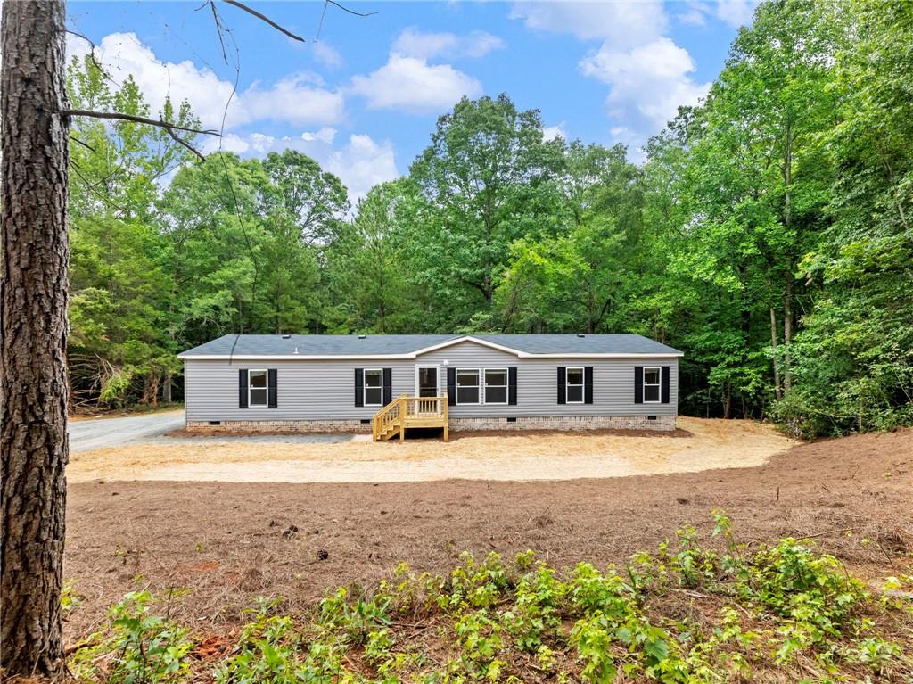 Brand New 2025 Live Oak Home on 2 Acres – FHA Ready! Beautiful new 2025 Live Oak manufactured home on a permanent foundation with brick skirting. This 1,768 sq ft home features 4 bedrooms, 2 bathrooms, and a large back deck—perfect for outdoor enjoyment. Located on 2 acres in Franklin County, the property includes a new septic system and well.
