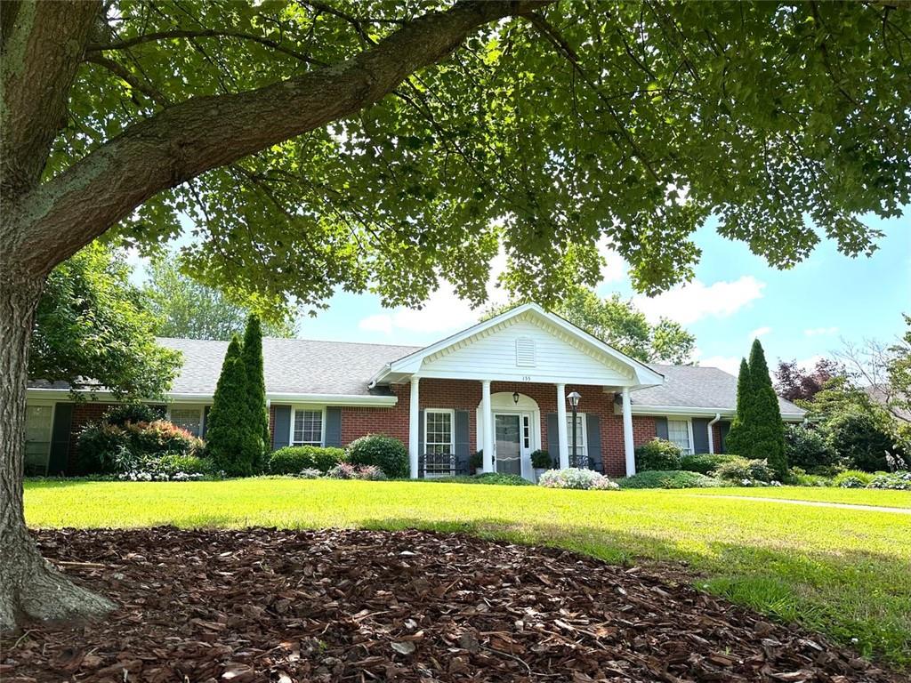 Very Hard to Find! This One Won't Last! Offering a beautifully updated, Chatham-built single-level home in one of Roswell's most sought-after close-in neighborhoods. Just under 2 miles from the vibrant historic district. This timeless, four-sided brick residence is on a level, beautifully landscaped corner lot and features classic traditional architecture, including a charming columned front porch and a no-step layout for seamless indoor-outdoor living. Enjoy your morning on the covered patio with sunrise views and relax in the shade during the evening. The home boasts a desirable rear-entry garage with a spacious parking pad ideal for family and guests. Inside, you'll find three oversized bedrooms, each with walk-in closets, thoughtfully positioned on one side of the home for privacy. On the opposite end, enjoy a garage workshop and a versatile, climate-controlled art studio or home office. Additional features include attic storage accessible by permanent, full-sized staircase and a level backyard with arbor entrance - perfect for entertaining or quiet enjoyment.