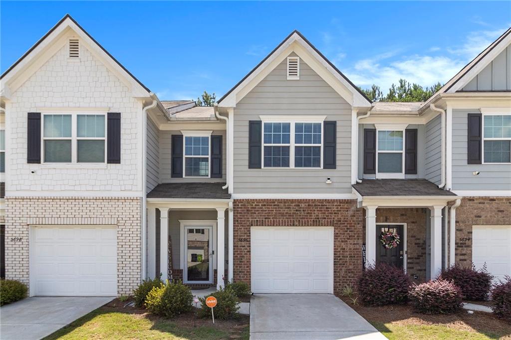Welcome to your next chapter in this gorgeous, well-maintained townhome! Featuring beautifully upgraded luxury vinyl plank flooring throughout the main level, the open-concept layout offers a spacious living room and separate dining area—perfect for both relaxing evenings and entertaining guests. You will love to cook in the galley-style kitchen, complete with granite countertops, stainless steel appliances, and a generous walk-in pantry for ample storage. All bedrooms are located upstairs with laundry for your convenience. The impressive owner’s suite boasts a large walk-in closet and a versatile sitting room—ideal as a home office, reading nook, or workout space. Step outside to your privately fenced backyard with a walkout patio, perfect for grilling, play, and visiting with friends. Enjoy the ease of maintenance-free living with HOA-included lawn care for both front and back yards. Don't let this one pass you by--schedule your showing today!