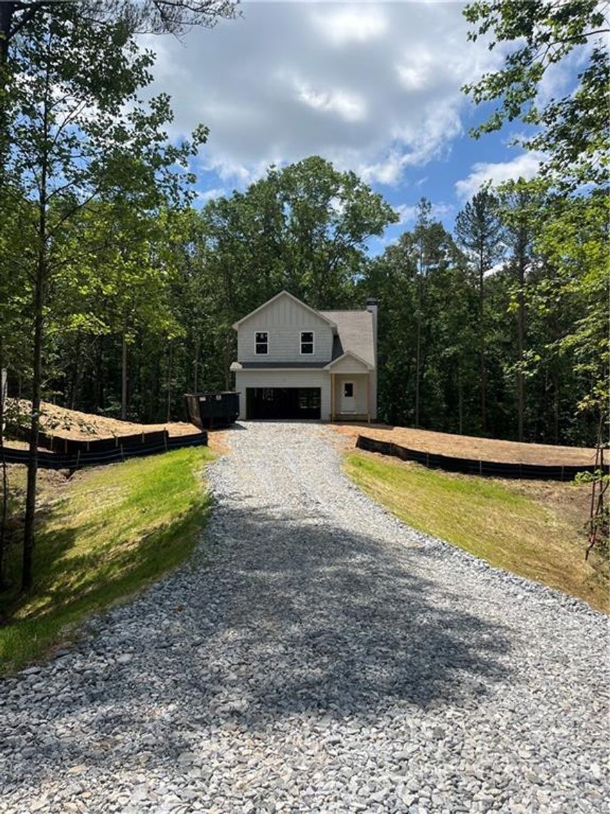 SO excited to announce  NEW CONSTRUCTION by Rivermont Homes in WEST WOODS! Fabulous location in Dahlonega just minutes from UNG campus offering Lumpkin county's finest schools and all the shopping close by in Dawsonville and the lovely downtown Dahlonega Square!!! The Jackson plan is a 3 bedroom 2 1/2  bath basement home situated on .60 of an acre with a private wooded view. Entering this fabulous home you have an open foyer leading to the living room which is open to a sun lit kitchen and dining room featuring quartz countertops, subway backsplash, and stainless steel appliances. A spacious master suite and the luxurious bath has a double vanity with quartz countertops, tile floor and large shower with bench. The 2 guest bedrooms offer ample space and closets with a shared hall bath. Home is under construction with completion by August 2025. STOCK PHOTOS of same plan.