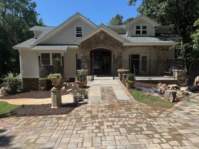 Discover unmatched craftsmanship and thoughtful design in this brand-new 7 bedroom 7 bathroom luxury home on a finished terrace level apartment, perfectly situated on a lush wooded home setting at the end of a peaceful street. This mountain like retreat in the city, with walking distance to Walton High School and zoned for TOP-RATED SCHOOLS is built by a retired builder with a lifetime of experience, where every inch of this property showcases quality and detail rarely found in today’s market. In addition to the 4 car garage, basement has large doors for easy access, and a circular driveway around the entire house provides even more convenience. Craftsman stonework compliments the courtyard and covered front porch, setting the tone for the elegance inside. Step through the foyer into an open and airy floor plan designed for modern living with a traditional feel offering breathtaking views from every room. The great room features a grand fireplace, and a large projection-ready wall for game days or gatherings. The open-concept dining area flows seamlessly into the show-stopping two story kitchen surrounded by a 360 degree balcony. Large island, granite countertops, bright tastefully color coordinated cabinetry including, glass display cabinets for an even more elevated feel, and high-end stainless steel appliances of your choice. You will be pleasantly surprised by the design elements in this space! Your eye is easily drawn from every room on the main level to the large covered porch and lake view. Your relaxation on this porch is enhanced by the exposed beamed ceiling and the craftsmanship detailed fireplace. The beautiful views continue in the MAIN-LEVEL PRIMARY SUITE featuring a sitting area, double vanity, freestanding soaking tub, dual shower heads, and an optional custom wardrobe. Two additional rooms on the main level offer flexibility—one currently serves as a library with a fireplace and private bath. Whereas the other room opens to the sprawling porch. Upstairs, you’ll find two en-suites and adjacent loft area. The FULL FINISHED TERRACE level expands your living space with a complete full apartment with its own private entrance and garage. Sports enthusiasts, we had you in mind! Whether it's a game on your pickleball court, working on your chipping and putting, or enjoying billiards, there are so many ways to kick back and enjoy life. Additional features include a sound system, high efficiency Lennox HVAC, and an irrigation system ready to extend to a garden. The spacious backyard is ready to be fenced for your furry friends with both foot and vehicular bridge. There’s even space for your dream pool or water feature. This is more than a home—crafted with meticulous attention to detail and offering endless possibilities for customization. With a neutral color pallet, take advantage of the builder’s expertise to tailor every feature to your style and bring your vision to life!! Conveniently located near major highways for a smooth commute, healthcare, and all the shopping, dining, and year around entertainment you can imagine.