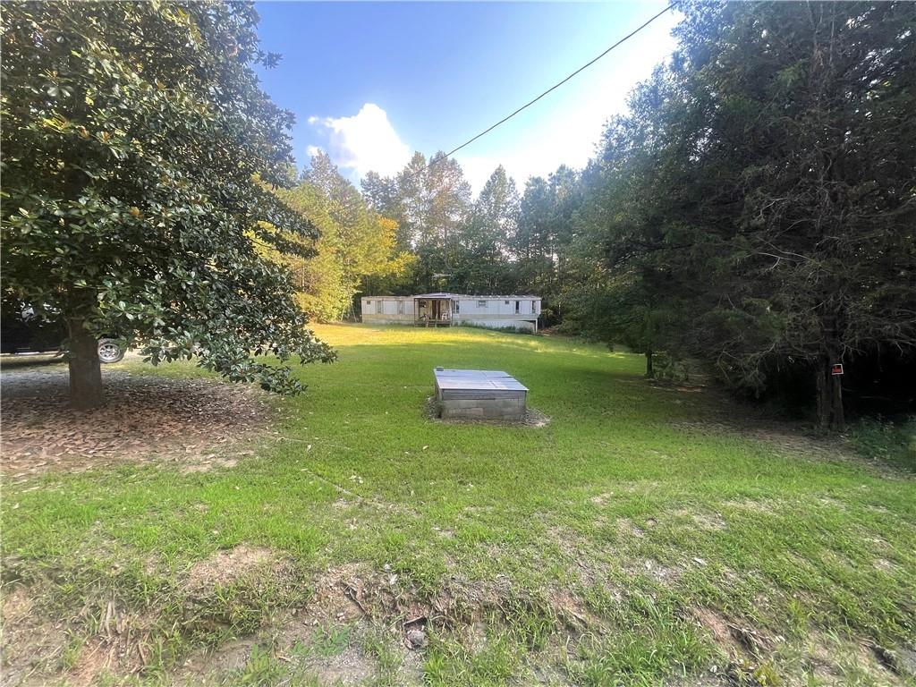 1.81 acres with frontage on both sides of Locklear Circle. Septic tank in place at the mobile home site. Possible potential to subdivide and create 2 residential lots on both sides of the road. Conveniently located just off Hwy 278, Goldmine Road and close to the Paulding County Airport. Many possibilities and much potential in this highly desirable area.