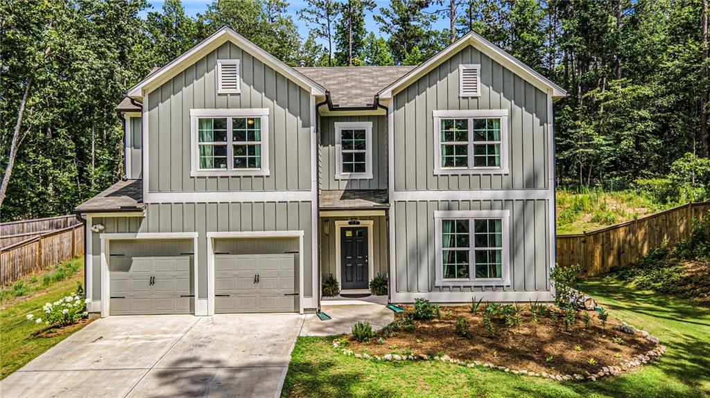 Perfectly situated on 2 ACRES, this beautifully maintained home offers a rare blend of privacy, character, and versatile living space, all within convenient proximity to everyday amenities. A long driveway with an extended parking pad ensures ample parking, while the board and batten exterior adds timeless charm and curb appeal. Step inside to discover a thoughtfully designed open-concept floor plan that flows effortlessly from room to room, enhanced by high ceilings and abundant natural light. The spacious living area serves as the heart of the home, offering warmth and comfort in a bright and airy setting. The kitchen is a standout, equipped with stainless steel appliances, a large center island, and a beautiful herringbone tile backsplash. A walk-in pantry adds function and flexibility, featuring a butcher block countertop with electrical outlets, ideal for keeping small appliances tucked neatly away yet easily accessible. The main floor includes two generously sized bedrooms, including a luxurious primary suite complete with a double vanity, a huge walk-in tiled shower, linen closet, water closet, creating your own retreat for rest and relaxation. The secondary bedroom on this level can be used as a guest suite, home office, or playroom, depending on your needs. Upstairs, a cozy landing leads to two additional large bedrooms. One of these is exceptionally spacious, currently used as a playroom and recreational area featuring a rock wall and ceiling hook for a hanging chair. Whether used as a hobby space, entertainment zone, or converted into additional bedrooms, the versatility of this space makes it a true highlight. Outside, enjoy your fully fenced and private backyard offering endless opportunities to create your dream outdoor space. Unwind on the patio under the SunSetter awning, or gather around the fire pit with the cooler months ahead. Whether you're gardening, entertaining, or enjoying a quiet evening under the stars, the wooded views creates a picturesque backdrop. This exceptional home combines modern comfort, natural beauty, and flexible living in one package.