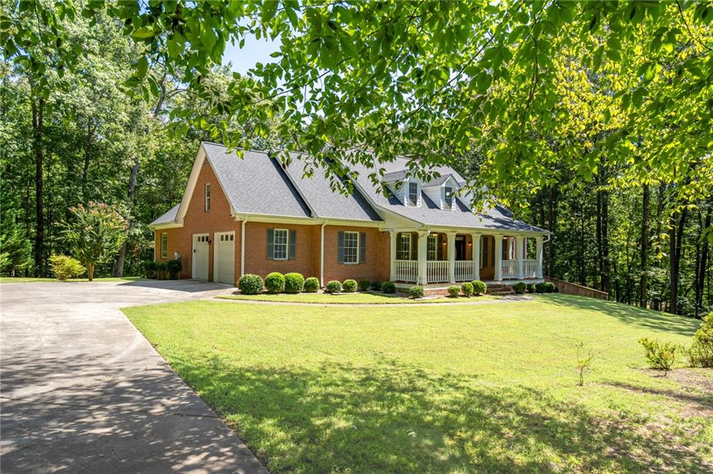 Spectacular Executive-style estate on almost 7 acres of gently rolling hills, mature hardwoods, and highly sought-after privacy. The residence, built in 2000, offers spacious living areas in addition to ample private sleeping quarters. True hardwood floors; traditional moldings and trim; plus over-sized windows bring warmth, character, and charm into this very special home. The generous-sized kitchen overlooks a sunny breakfast area with direct views to the heart of the home...the family room. The family room; with cozy, wood-burning, masonry fireplace and custom built-ins; opens to a lovely, light-drenched sunroom providing beautiful vistas of the rear yard and wooded landscape. Also located on the main level is the master suite...quietly tucked away from the rest of the living areas of the home...which includes an en suite bath (with both a separate shower and garden tub) and substantial walk-in closet. Two secondary bedrooms are located on the main floor with each providing direct access to a full bath. Upstairs, the living quarters include a bedroom room, full bath, and a very spacious flex space (perfect for a playroom, game room, media room, secondary den, or more). The HUGE unfinished attic area provides unlimited potential for additional expansion. The full-sized basement, with secondary, masonry fireplace and plumbing access, is as endless as the possibilities you can imagine for creating separate spaces for each member of the family! The location is UNPARALLELED in its seclusion, privacy, and tranquility, and all within approximately 4 miles to GA400/19 at Hwy 53...an area known for some of North Georgia's best shopping, dining, and more! An opportunity, such as this, providing the best of both worlds is a rarity! Don't miss out. Check out the photos and schedule your appointment to see it in person. Listing Agent is related to Seller.