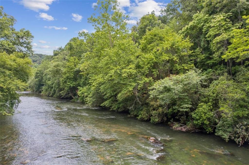 Stunning RIVERFRONT Lot on the Cartecay! Enjoy nearly 122 feet of direct river frontage with property lines extending to the center of the Cartecay River-perfect for tubing, kayaking, fishing, or simply relaxing by the water. Best-suited for a walk out basement - maximize the lot's natural elevation to create a spacious and versatile home. No mandatory HOA fees and no rental restrictions, offering flexibility for personal use or investment. City water connection available along with high-speed internet and paved roads all the way to the property to name a few of the many perks! Ideally located less than 10 minutes from charming Downtown Ellijay, this is your chance to own a piece of peaceful, riverside paradise. Adjoining lots #4 (.66 acre), #5 (.74 acre), #6 (.89 acre) also available!