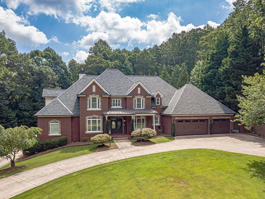 Executive or Equestrian Estate in The Desirable Loganville High School District! 7 Bedrooms | 5.5 Baths | Saltwater Pool | Barn & More! Resting on 5.40+- Acres This Stunning Gated Estate offers a rare blend of elegance, comfort, and versatility. Exterior features 4-Sided Brick Finishes with Stone Accented Custom Windows-Commanding Curb Appeal with Professional landscapes and show-stopping GAF Camelot 2 roof! This elegant and luxurious designer shingle adds a touch of sophistication and style to the exterior of this immaculate property. The diamond cut design and oversized tabs of the Camelot 2 shingle create a beautiful, textured look that will surely impress all who pass by. The open valley , exceptional craftsmanship and attention to detail of the roof perfectly complement this beautiful estate home! The Front Entry has covered front porch with brick flooring! Custom Front Entry Double Door with Glass greet you as you step inside the grand foyer with a tiled entryway. Take in the rich hardwood flooring and detailed crown molding throughout the main level. The chef's kitchen features built-in double ovens, granite countertops, an abundance of elegant, destressed cabinets, recessed lighting, pendant lights, wine rack, eat-in area, and a separate dining room. Kitchen Overlooks The living room which includes custom built-in cabinets, recessed lighting, detailed lighted tray ceiling, stone accented fireplace and a whole-home intercom system. Family room overlooks the Covered Rear porch and pool area. The main-level owner's suite is a true retreat with a marble fireplace, spa-like ensuite featuring an oversized tub, walk-in tile shower, and a huge custom closet system. Main Level Features an Executive's Office with Triple Trey Ceiling, Oversized Entertainment Room Currently used as a Billiards room with Bar Area and Brick Fireplace, Laundry Room with Cabinets and Sink-A guest bedroom with built-in bookcases and a private bath is also on the main level. Upstairs you'll find three large secondary bedrooms and two full bathrooms-Fresh paint and carpet is a plus! Head downstairs to your personal entertainment haven complete with a movie room with projector, plenty of space to customize your home gym, full kitchen, laundry hookups, two additional bedrooms, and a full bath. Outside, enjoy the covered rear porch with oversized stone fireplace and flagstone flooring overlooks your saltwater inground gunite pool with an expansive pool deck perfect for entertaining. This Estate Features a front entry 3 car garage with custom mud benches, 1 side entry garage on the terrace level and a detached 2-car garage on the rear of the property that includes a finished bonus space above the parking area with HVAC. A secondary building with a wraparound porch was previously used as an indoor archery range with a sitting area would be great for a Man Cave-Game Room-Or Family Gathering area. Tons of paved parking area for guests. This Property is an Equestrian Lovers dream with over 5 acres, the property includes a two-stall barn, paddock, and riding arena. Tons of pluses, including Professional Landscaping Services Paid for until Dec 2025, irrigation system, new septic field lines installed with risers in July 2025, new HVAC systems within the last 2-3 yrs. All new plumbing for the pool, new pool motor and pool lights! Schedule your showing of this beautiful home TODAY!