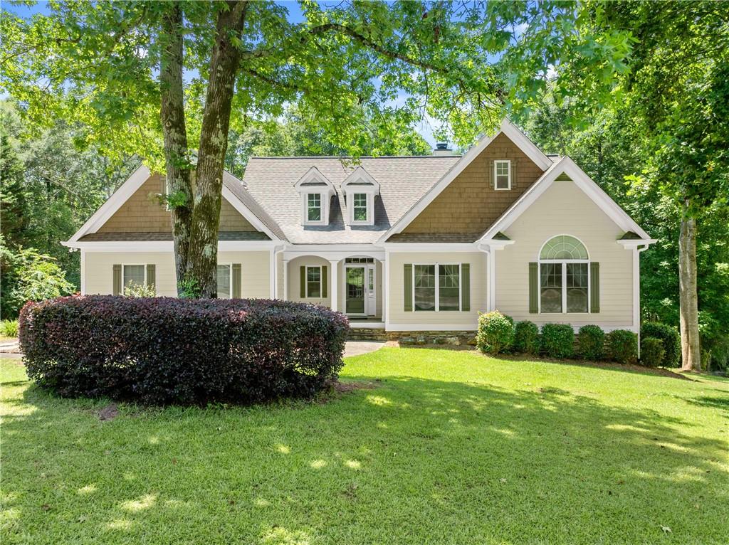 Welcome to 379 Sweetwater Ridge in beautiful Hoschton, GA - a spacious and versatile 5-bedroom, 3-bathroom home nestled on nearly 2 acres with a serene creek running through the property! From the moment you step inside, you'll be greeted by warm hardwood floors and an inviting open-concept living area flooded with natural light. The spacious living room flows seamlessly into the kitchen, with both areas offering direct access to the back balcony - the perfect spot to relax and take in peaceful views of the wooded backyard. The master suite on the main level is a true retreat, featuring charming wood accents that give it a cozy, cabin-in-the-mountains feel. Two separate closets offer generous storage, and the master bath boasts double vanities and a soaking tub ready for your relaxation. Upstairs, a large bonus room offers endless possibilities - use it as a bedroom, office, home gym, or playroom to suit your needs. But the real surprise is downstairs. The finished terrace level features two oversized media or living rooms, a spacious additional bedroom and full bath, and private access to its own 1-car garage - ideal for multi-generational living, entertaining, or potential rental income. You'll also find a large workshop/garage with built-in shelving, perfect for hobbies, projects, or additional storage. Recent updates and maintenance include: New garage door & opener (Jan 2024) New garage door springs (Oct 2024) Septic tank pumped (2012, 2017, & 2023) Septic Pump & risers installed (Mar 2017) Concord HVAC system installed (July 2019) Southeastern Underdeck System added (April 2018) New roof by KCI Roofing (March 2015) Fresh paint inside & out (April 2023) Back windows tinted (June 2018) Outside, enjoy the peace and privacy of this partially wooded lot with a meandering creek - perfect for peaceful walks, outdoor play, or enjoying nature. The property also includes extra parking, multiple garage spaces, and room to spread out and make it your own. This home has been lovingly maintained and thoughtfully updated, making it move-in ready and full of potential. Don't miss your chance to own this unique and spacious property in a quiet and desirable Hoschton location!