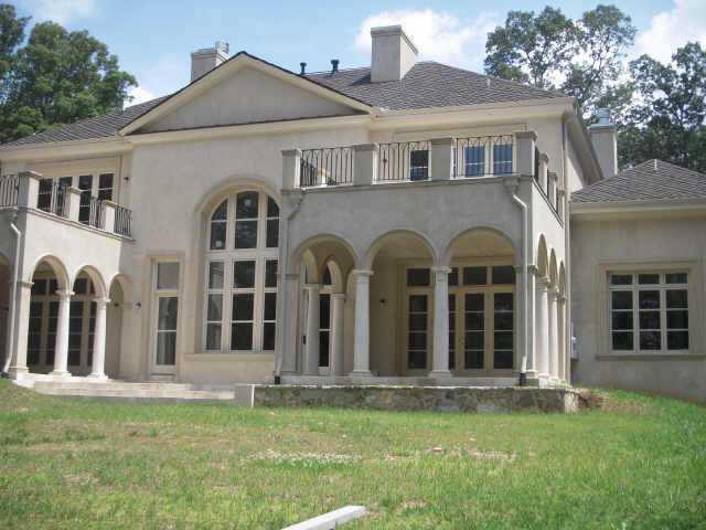 Classic architecture by Harrison Designs. Impressive true estate home sits majestically on 2+ acres of wooded privacy. Built w/ hardcoat stucco over concrete blocks. Interior boasts limestone stair treads, mantels, wall accents. Beautiful handcarved solid wood doors thru-out. Sep 3 bdrm guest house.
