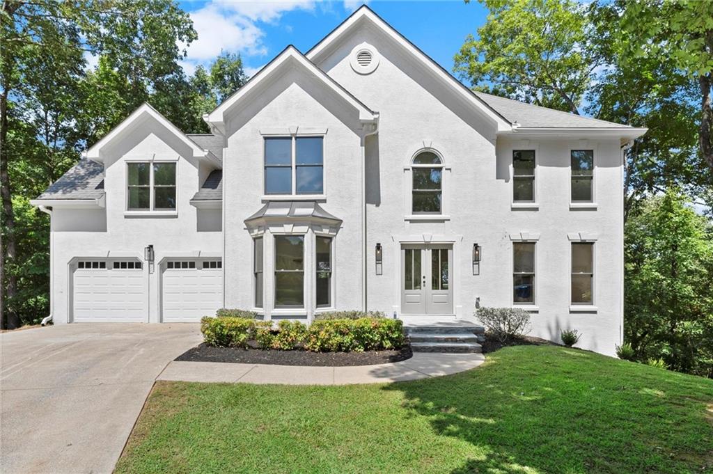 Create lasting memories in this beautifully reimagined home, offering the perfect blend of modern design and everyday comfort. Step inside to an open-concept living space filled with natural light, vaulted ceilings, and a wall of windows overlooking private wooded views. The designer kitchen features new white shaker cabinetry, quartz countertops, a farmhouse sink, tile backsplash, and a premium stainless-steel appliance package including a 36” range. The adjoining family room features a brick fireplace, recessed lighting, and seamless flow to the new open-air deck—perfect for entertaining or simply relaxing outdoors. Upstairs, the primary suite is a true retreat with a vaulted ceiling, new carpet, and a spa-inspired ensuite featuring a glass shower, quartz double vanity, and designer tile and fixtures. Secondary bedrooms are fully updated with new flooring, lighting, and a stylish shared bath. The finished terrace level with a full bathroom provides even more space to entertain or unwind, complete with a new wine bar, luxury vinyl flooring, a private bedroom, and additional storage—perfect for guests or recreation. From top to bottom, this home shines with new paint, flooring, doors, trim, fixtures, appliances, HVAC, and professional landscaping. With a two-car garage, freshly built deck, and move-in-ready appeal, this property combines high-end finishes with an unbeatable location. Situated just minutes from downtown Woodstock’s shops, dining, and parks—with easy access to I-75 and I-575—this home offers both convenience and lifestyle. Don’t miss your chance to own this entertainer’s dream in one of Woodstock’s most desirable locations.