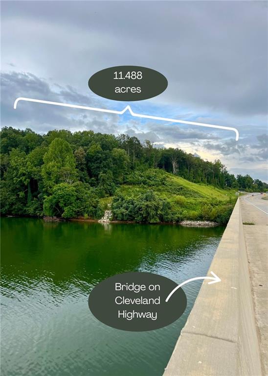 This rare 11.488-acre Lake Lanier property offers 638 feet of stunning lake frontage. Although the Corp. frontage is redlined (no docks allowed) this frontage provides breathtaking views, calm water and tremendous potential. Primarily wooded with mature hardwoods and a few pines, this elevated property offers privacy, natural beauty, and walking trails allowing you to explore every angle of the acreage. The property is conveniently located at the corner of Cleveland Highway and Lakeview Street, with approximately 640 feet of road frontage on Cleveland Highway and approximately 481 feet along Lakeview Street. Concrete driveways provide access from both streets.
The elevation of this acreage allows big water lake views along its own shoreline and also across the highway. There are multiple potential uses for this unique parcel, ranging from building one spectacular home with panoramic lake views, developing the land into multiple estate lots, creating a small subdivision, townhomes, or even condominiums. Priced attractively to move quickly, this is a truly unique opportunity to own prime, wooded lakefront acreage in a convenient location less than an 8-minute drive from downtown Gainesville. Schedule your showing today!