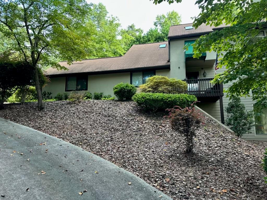 **Location, Location, Location!**
*Close to everything Marietta has to offer, Shopping, Dining, Schools and more!*
Come in to this open living room that impresses with soaring two-story windows filling the home with natural light and a tranquil views. The generous dining area is perfect for entertaining. The kitchen features a professional grade stovetop and wall oven with a large wood-topped island prep area. Abundant cabinetry, and a cozy eat-in area along with a desk make it complete. The main level offers a guest bedroom and full bath. Upstairs, the oversized primary suite boasts two large closets in the bathroom, a stepless shower and a skylight in the shower gives ample space to unwind. An additional bedroom includes a full bath and double closets. The finished basement expands your living space with a large family room featuring built-in bookcases, a full bath, wet bar, and a spacious storage room.
Tucked away on a private, serene lot, this uniquely designed home welcomes you with a long, wooded driveway and beautiful hardwood floors. Enjoy the spacious screened-in porch or host gatherings on the open back deck overlooking the landscaped backyard.
A true peaceful retreat, this property combines privacy, comfort, and beautiful natural surroundings.