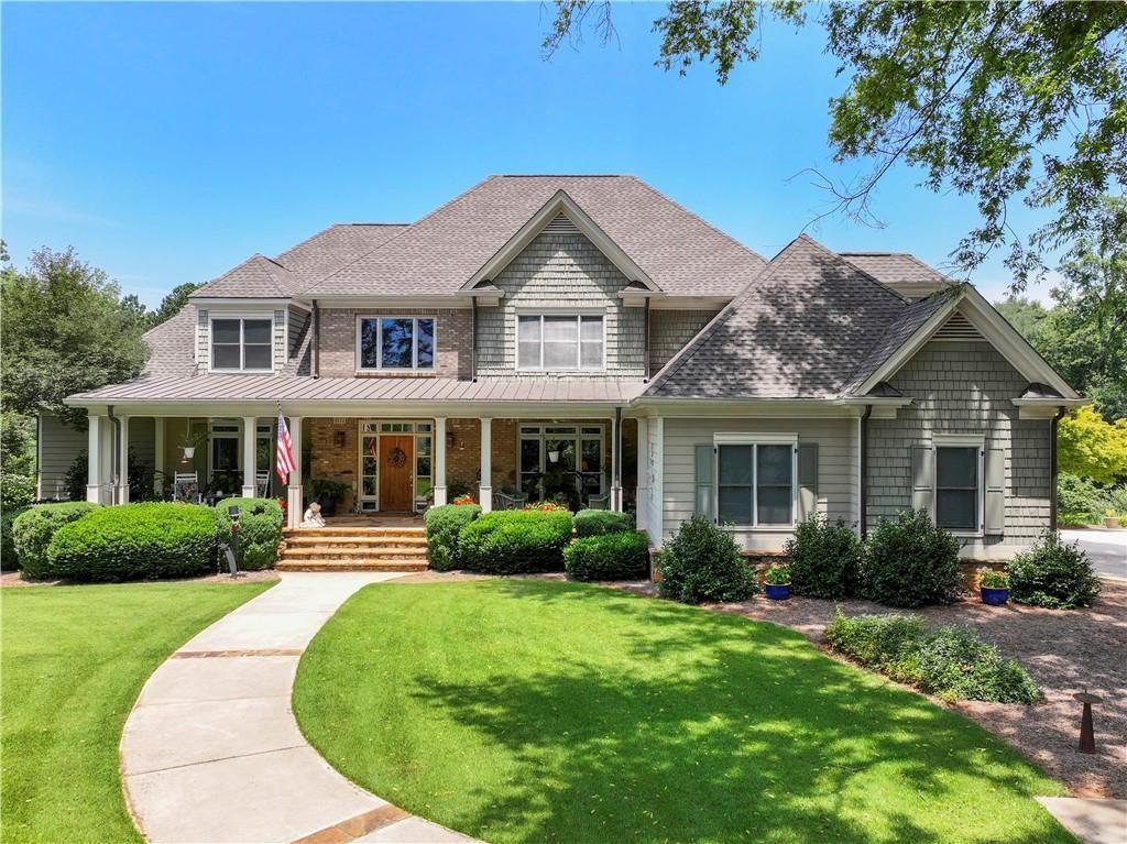 Welcome to your dream home in the heart of Hoschton! Bring your RV, Boat, and all the vehicles with plenty of parking space and NO HOA. This exquisite quality built residence offers endless possibilities with 1.7 beautifully level landscaped acres. NEW ROOF, NEW WATER HEATERS, AND ALL 3 HVAC SYSTEMS ARE NEWER. Plenty of space for the entire family with almost 6500sq.ft., 5 oversized bedrooms and 5 bathrooms. Easy access to the entire home with your own TOWNHOME STYLE ELEVATOR!! As you enter the home you are greeted with a huge front porch, 2 story foyer, great room with 18 foot wooded ceilings and plenty of natural light, 16 by 14 dining room, gourmet kitchen that is a chef's dream, featuring custom built cabinets with lighting, granite, double farm sink with touch control faucet, Island with a vegetable sink, Double Sub-Zero refrigerator/freezer with matching cabinetry doors, 6-burner Thermador Gas range, Thermador Double Oven, warming drawer, Built-in Gaggenau deep fryer, Sub-Zero wine cooler, and a spacious walk-in pantry. Large keeping room with a wood burning fireplace and 16 foot sliding doors to enjoy a great view of the private backyard and wildlife. Office on the main level with built in bookshelves. Master ensuite on the main level with french doors to the back patio, master bathroom features his and hers walk in closets, double vanity, dressing vanity, spacious jacuzzi tub, and walk in shower. You will love the antique heart pine floors throughout the main level, great room ceiling, and upper floor hallways and sitting area. The heart pine, sourced from a 200-year-old warehouse in Savannah, GA. Upstairs has 2 en suites with their own private bathrooms and large walk in closets. 2 other spacious bedrooms and another bathroom are perfect for a large multigenerational family. Also, a large sitting area overlooking the family room below. Unfinished basement is stubbed with walls, kitchen/bar, full bath, bedroom, and powder room. Gas-log fireplace is also in the basement and matches the fireplace in the great room. Ready for the new owners to add the finishing touches. Ground level rear garage with utility sink is accessible from the basement, perfect for lawn equipment/tools/storage. One of the best features of the home is the back deck running the length of the home on the main level and basement and has 2 covered areas, the deck is made of steel and concrete. Perfect area to enjoy the private backyard and heavily landscaped green space (Zoysia grass) and variety of unique trees and plants. Best of all the irrigation system is ran off the well water from the well located by the beautiful southern garden home perfect for storage. This truly is a gardeners paradise or someone that wants to enjoys the outdoors. Landscape tree-lights. Plenty of parking space for the camper, boat, or extra vehicles. GAS GENERAC is only a few years old. Great location with easy access to HWY85, shopping, restaurants, and excellent Jackson County schools. LOTS 1 and 3 are currently listed on mls. You can buy the entire 5 acres with 465 feet of road frontage. Perfect for a multifamily property!!!