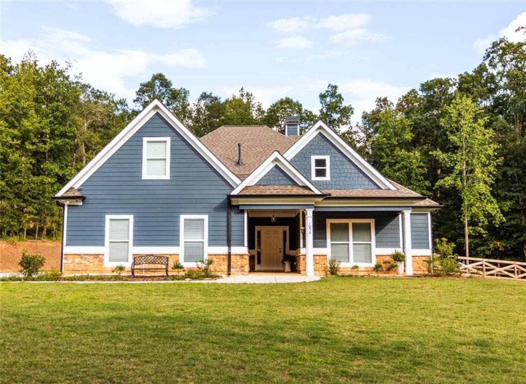 Your Modern Farmhouse Retreat Awaits! Nestled on a picturesque 2-acre lot in one of the area's most sought-after communities, this farmhouse-inspired beauty blends rustic charm with modern comfort. Step inside to a large open floor plan where the living room, kitchen, and dining area flow effortlessly-perfect for lively gatherings or cozy nights in! The chef's kitchen shines with sleek stainless steel appliances, a stylish breakfast bar, and plenty of counter space for your culinary creations. Relax in the peaceful screened-in porch, or host unforgettable BBQs on the adjoining patio while enjoying tranquil views of the backyard. The fenced side-yard offers a secure haven for pets and kids, and the level grounds are ideal for gardening, play, or simply soaking up the sunshine. The oversized owner's suite is a true retreat, complete with a spa-like bathroom featuring a spacious tiled shower. Two additional bedrooms and a full bath are conveniently located on the main level, while upstairs offers a versatile bonus room with its own private bath-perfect as a guest suite, home office, or game room. And with a small third bay garage, you'll never run out of space for vehicles, hobbies, or storage. Another great feature for the area according to the current owner is that you are in Zone 5 and can choose to go to Social Circle city schools. Come and See it while you can!