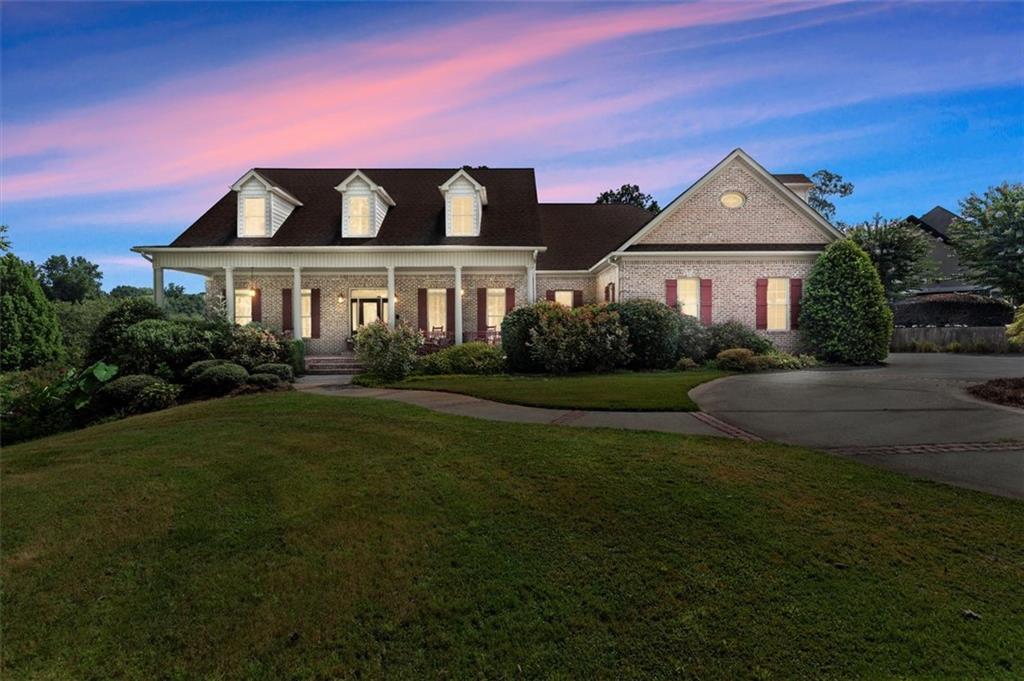 Welcome to lakeside living at its finest in this expansive retreat boasting over 6,000 total finished sq. ft. home, perfectly situated on a 1.65-acre big-water lot in the coveted Lake Walton Estates community. With breathtaking panoramic lake views, multiple outdoor living spaces, and a layout designed for flexibility, this home delivers a rare opportunity to own your own slice of paradise.
Inside, natural light pours into the open, airy floor plan where spacious living and dining areas seamlessly blend for both everyday comfort and entertaining. The kitchen features double ovens, ample storage, and endless potential to customize your dream culinary space.
The main-level primary suite is a true retreat offering sweeping lake views, a spa-inspired bath, and private deck access. Upstairs, you’ll find two generous bedrooms and a loft ideal for family, guests, or office space.
The 2,403 sq. ft. fully finished terrace level is a showstopper, complete with a second full kitchen, a media room, a gym, and a private guest suite. Plus, there's 452 sq. ft. of unfinished storage ready for your personal touch. Whether you’re hosting friends, planning for multi-generational living, or creating the ultimate game-day retreat, this level is designed for it all.
Step outside and experience the ultimate in outdoor living. Multiple covered decks and patios overlook lush greenery and a 300+ acre lake, perfect for fishing, kayaking, boating, morning coffee, afternoon barbecues, and sunset cocktails. The 2-car side-entry garage, circle driveway, and beautifully landscaped grounds complete the picture.
Located within a gated community with swim, tennis, clubhouse, and a community dock for lake access, this home blends luxury living with a relaxed, resort-style atmosphere.
HIGHLIGHTS: Covington address-Walton County schools; 300+ acre lakefront; Fishing, kayaking, boating, swim, tennis, clubhouse, and community dock